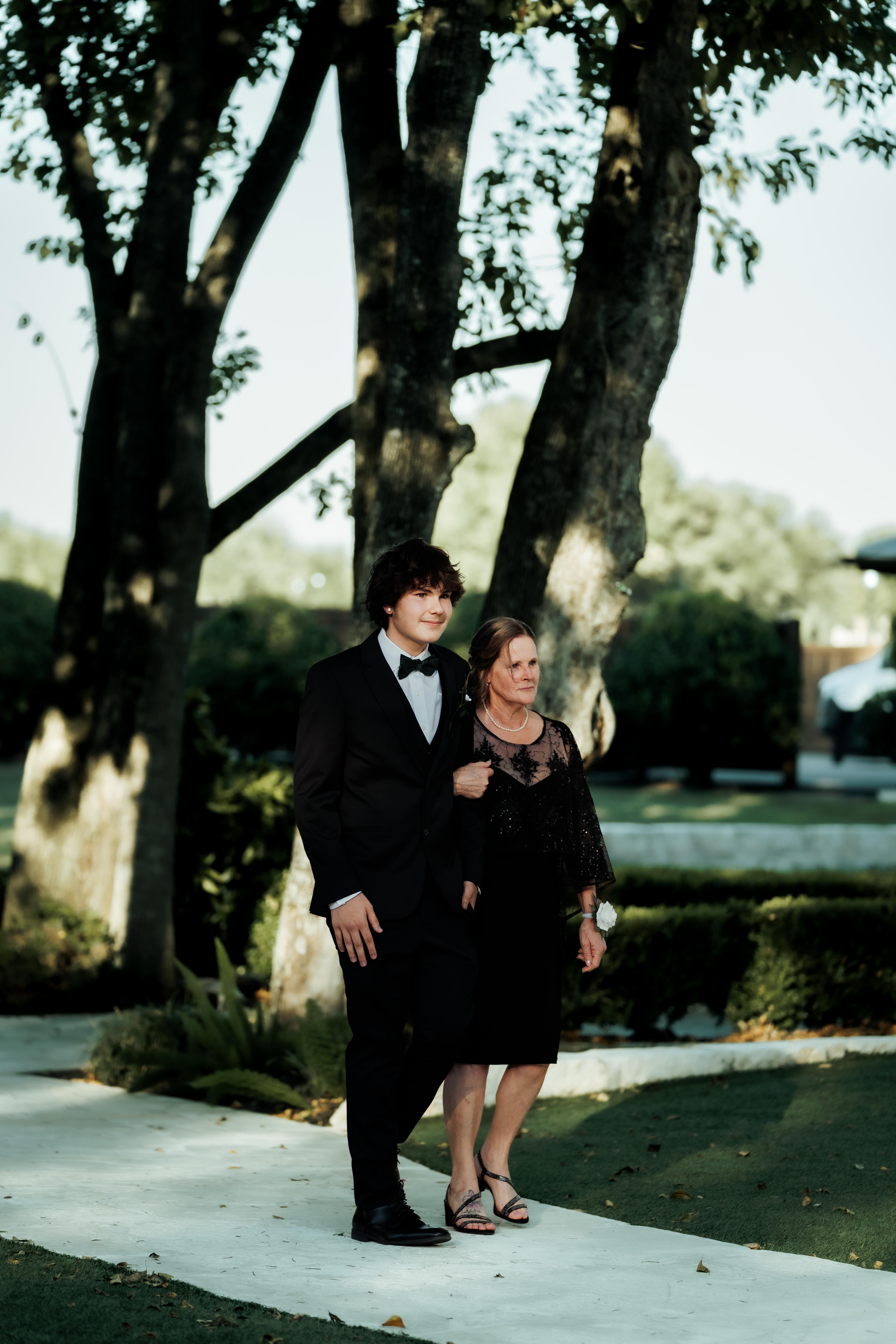 A man and woman standing on a sidewalk
