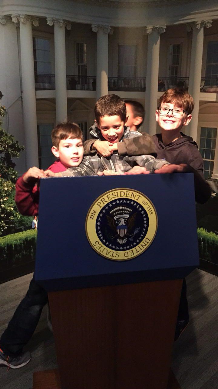 A group of boys hugging in a podium