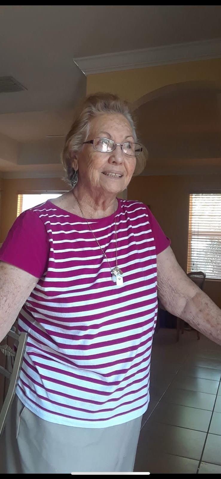 A woman wearing glasses and a striped shirt