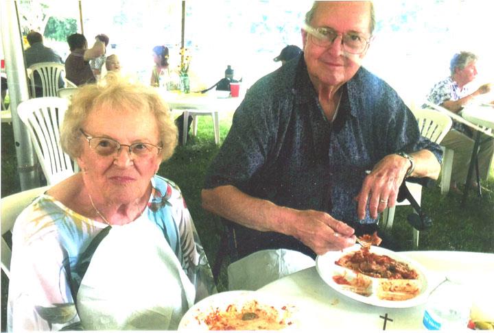 A man and woman eating food