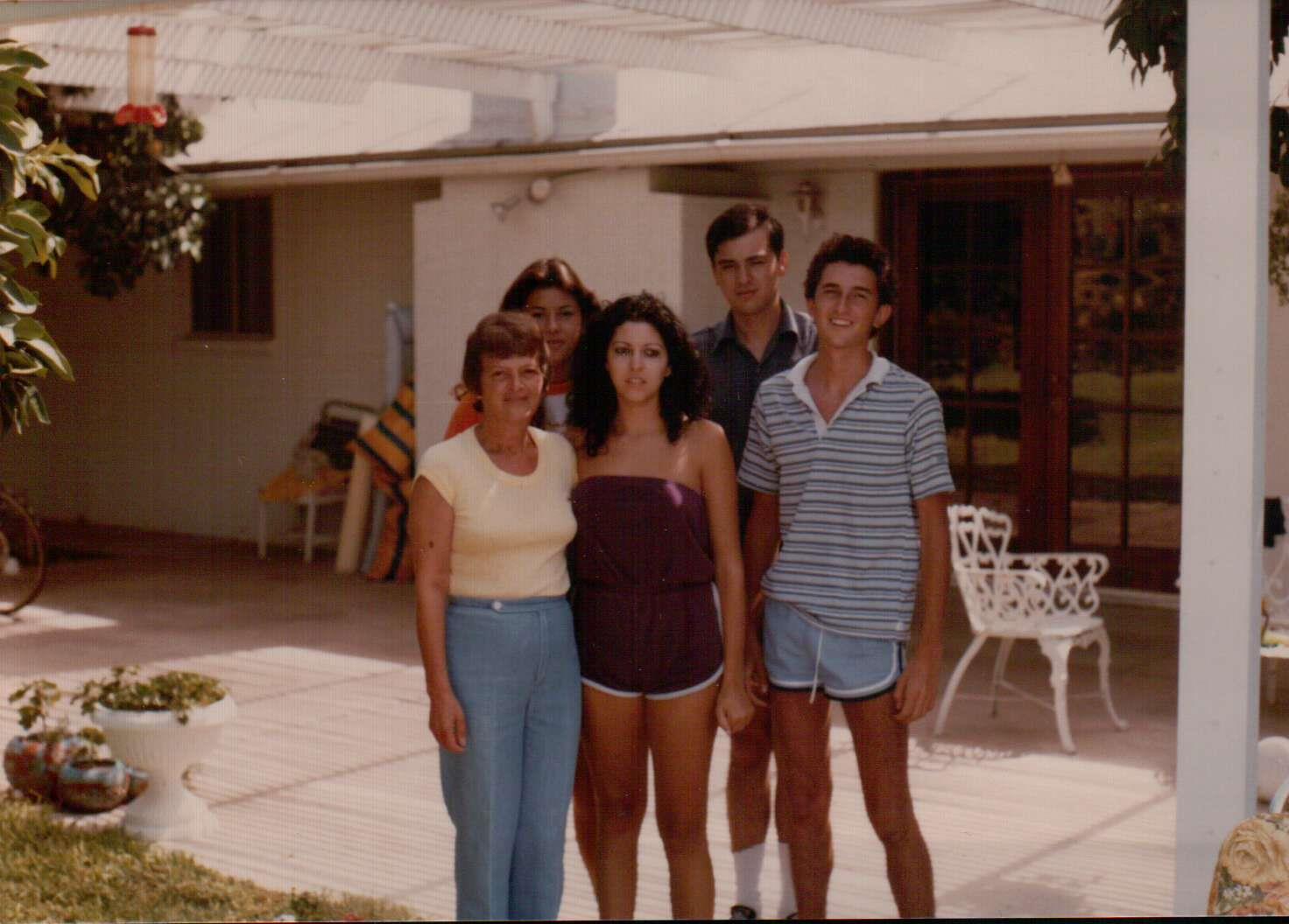 A group of people standing outside a house