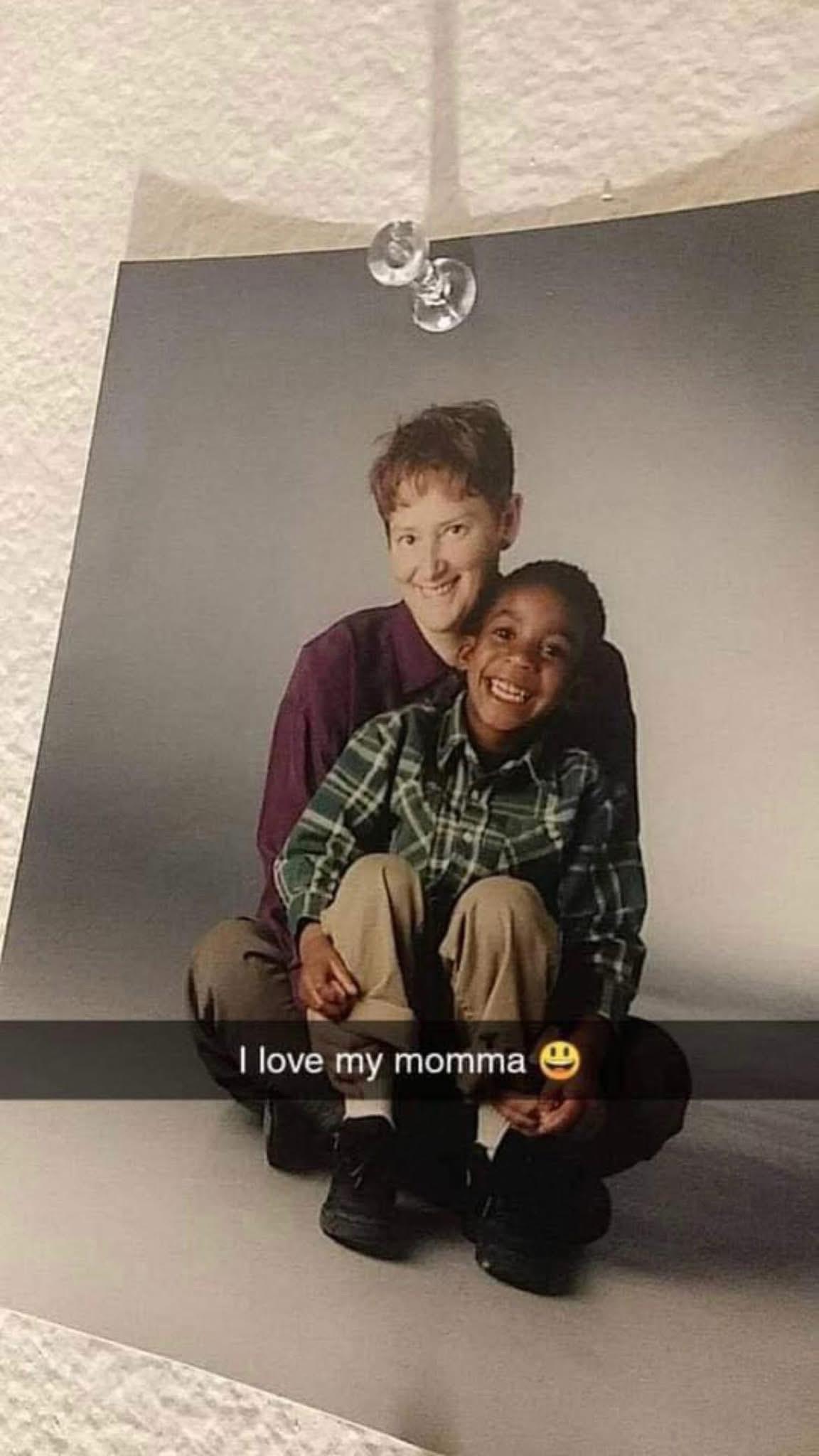 A woman and boy sitting on a floor