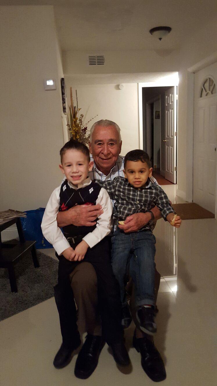 A man holding two boys
