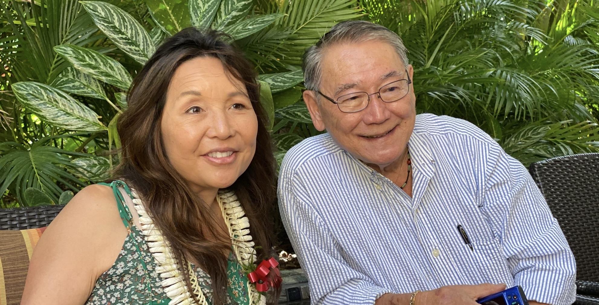 A man and woman smiling