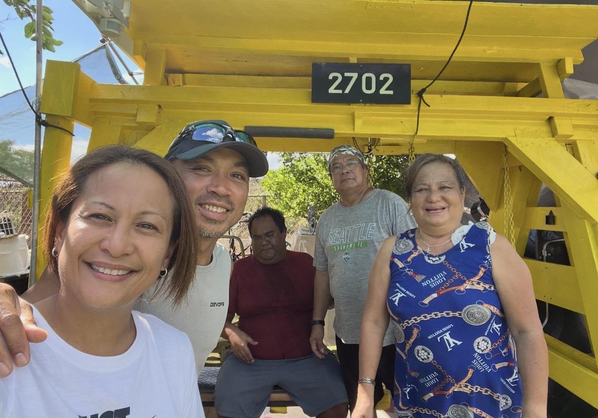 A group of people standing in a yellow vehicle