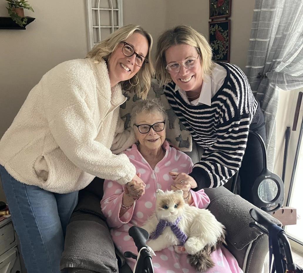 A group of women holding hands and a woman in a wheelchair