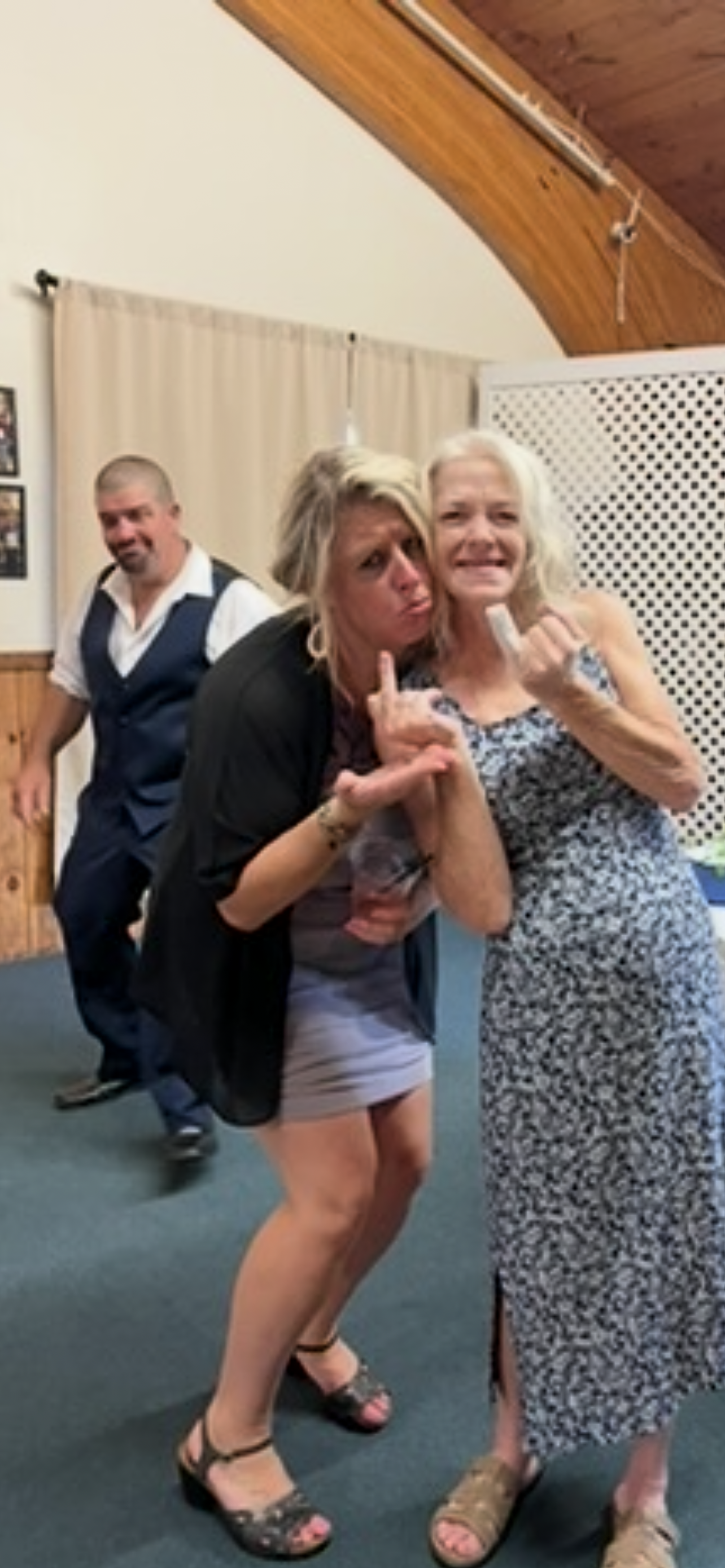 A woman making a funny face with her hand
