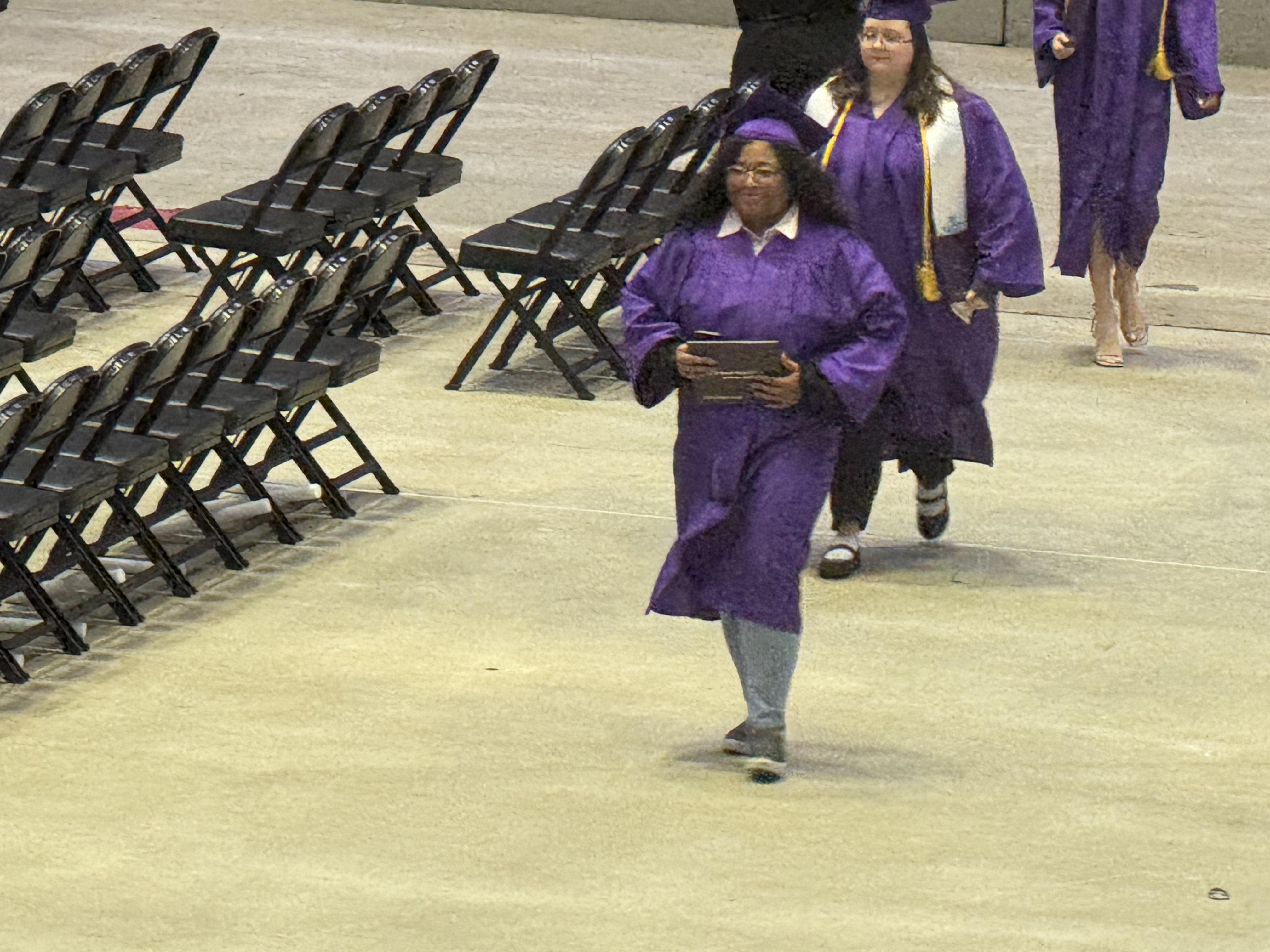 A group of people in graduation gowns and cap and gowns