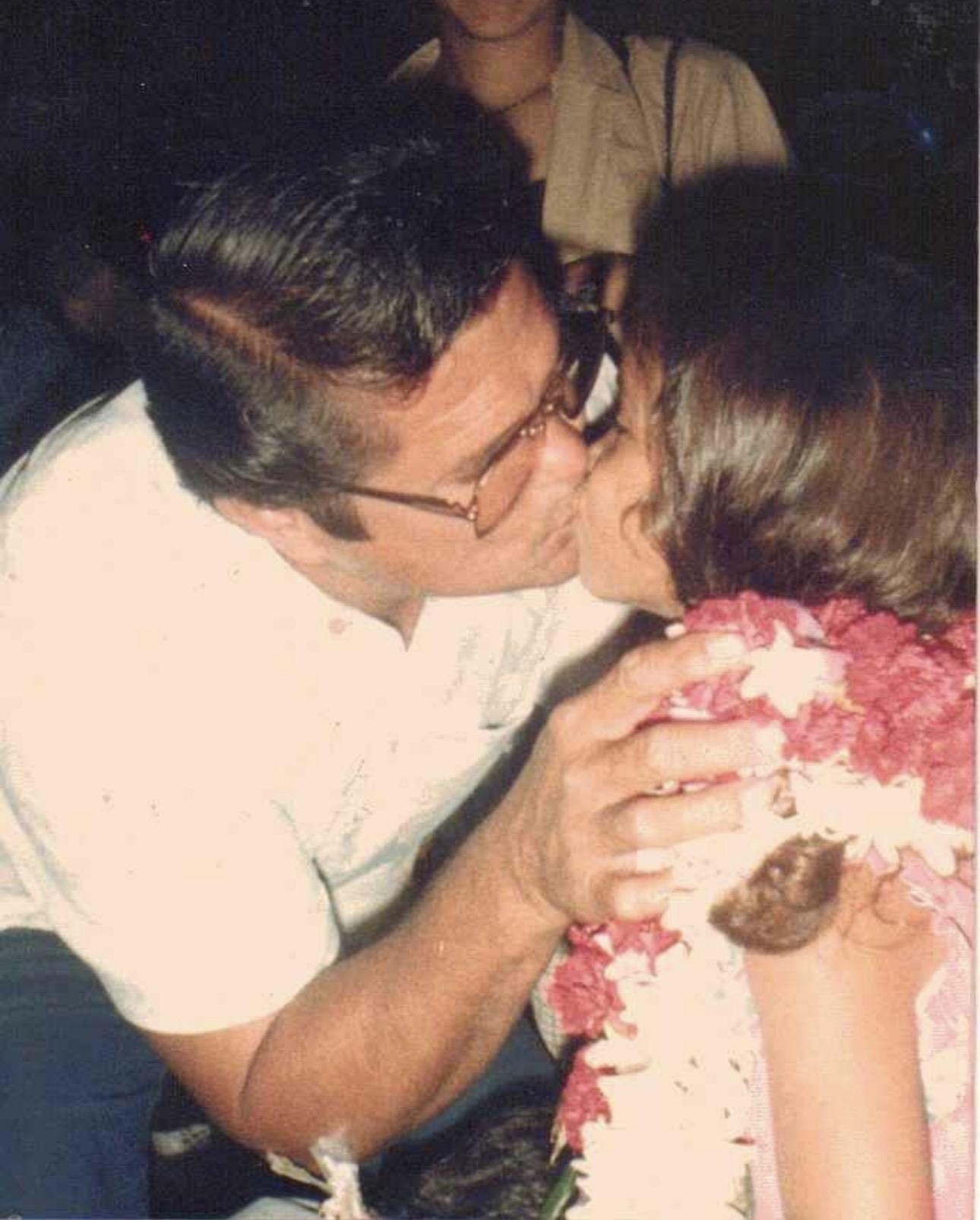 A man kissing a child