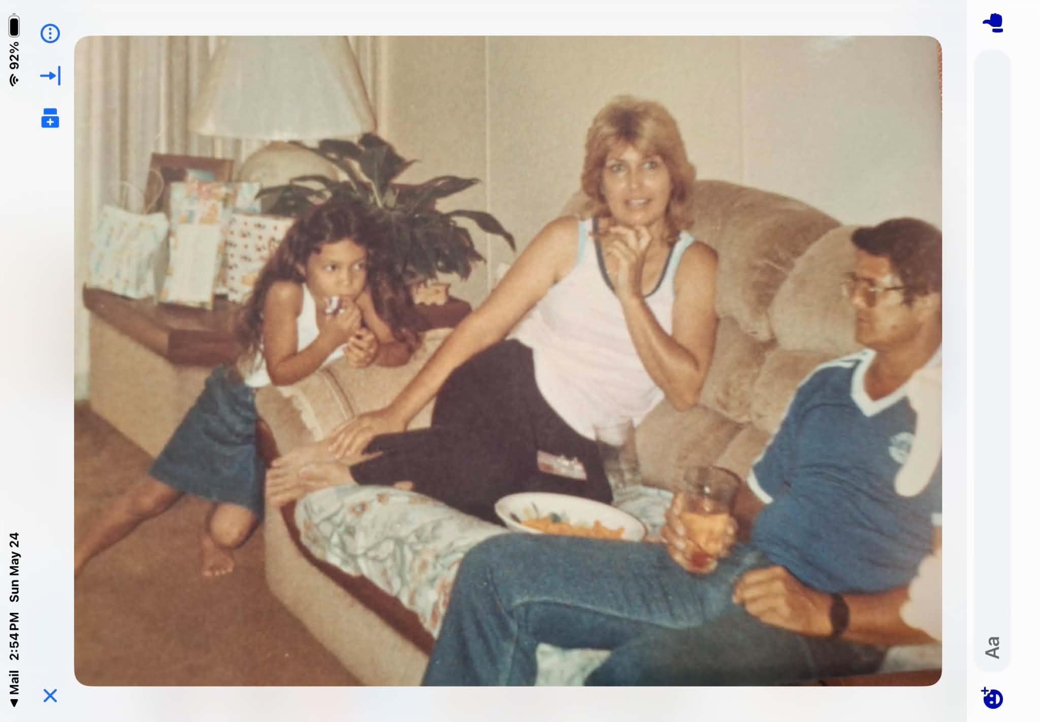 A family sitting on a couch eating food