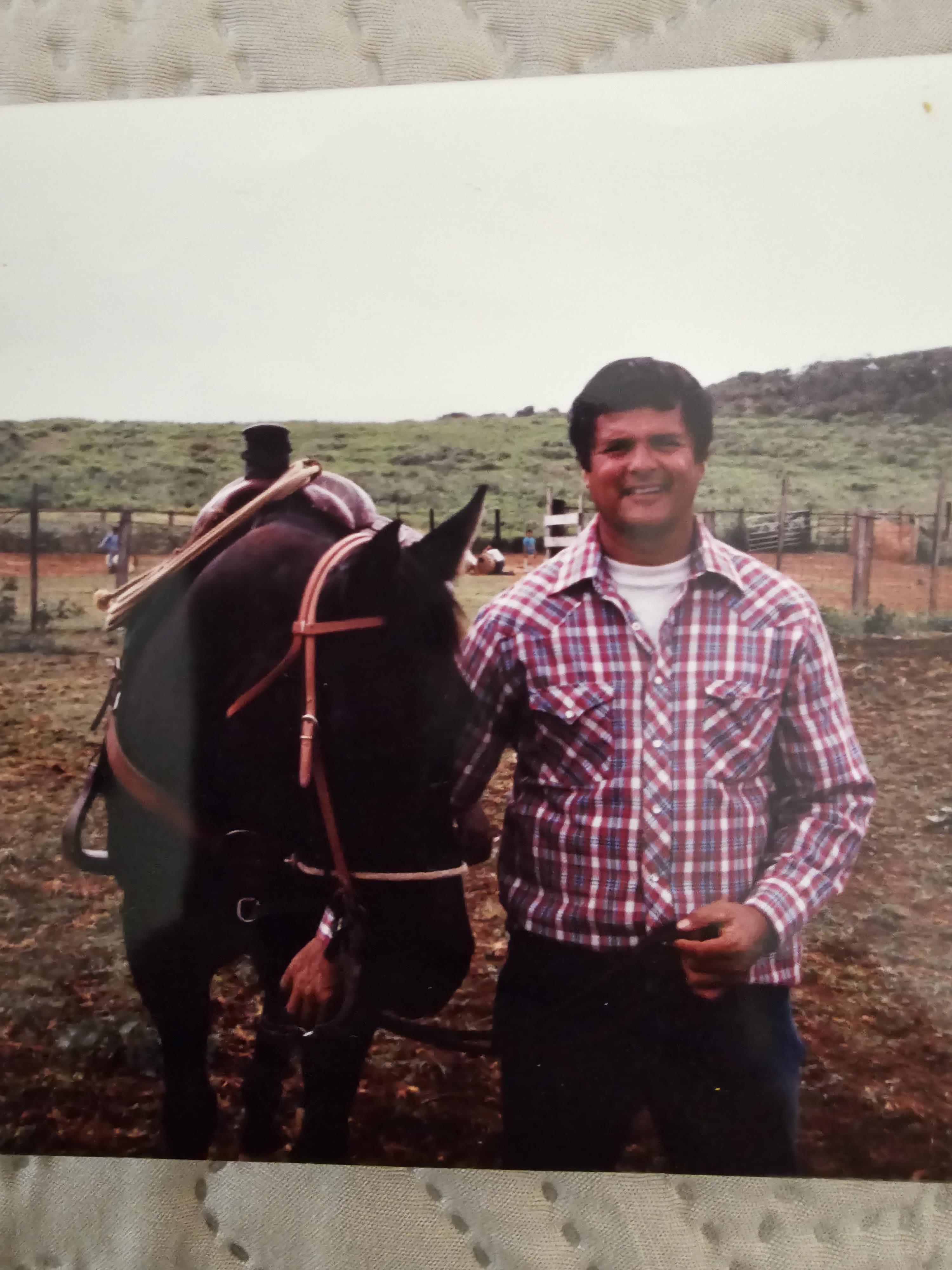 A man standing next to a horse