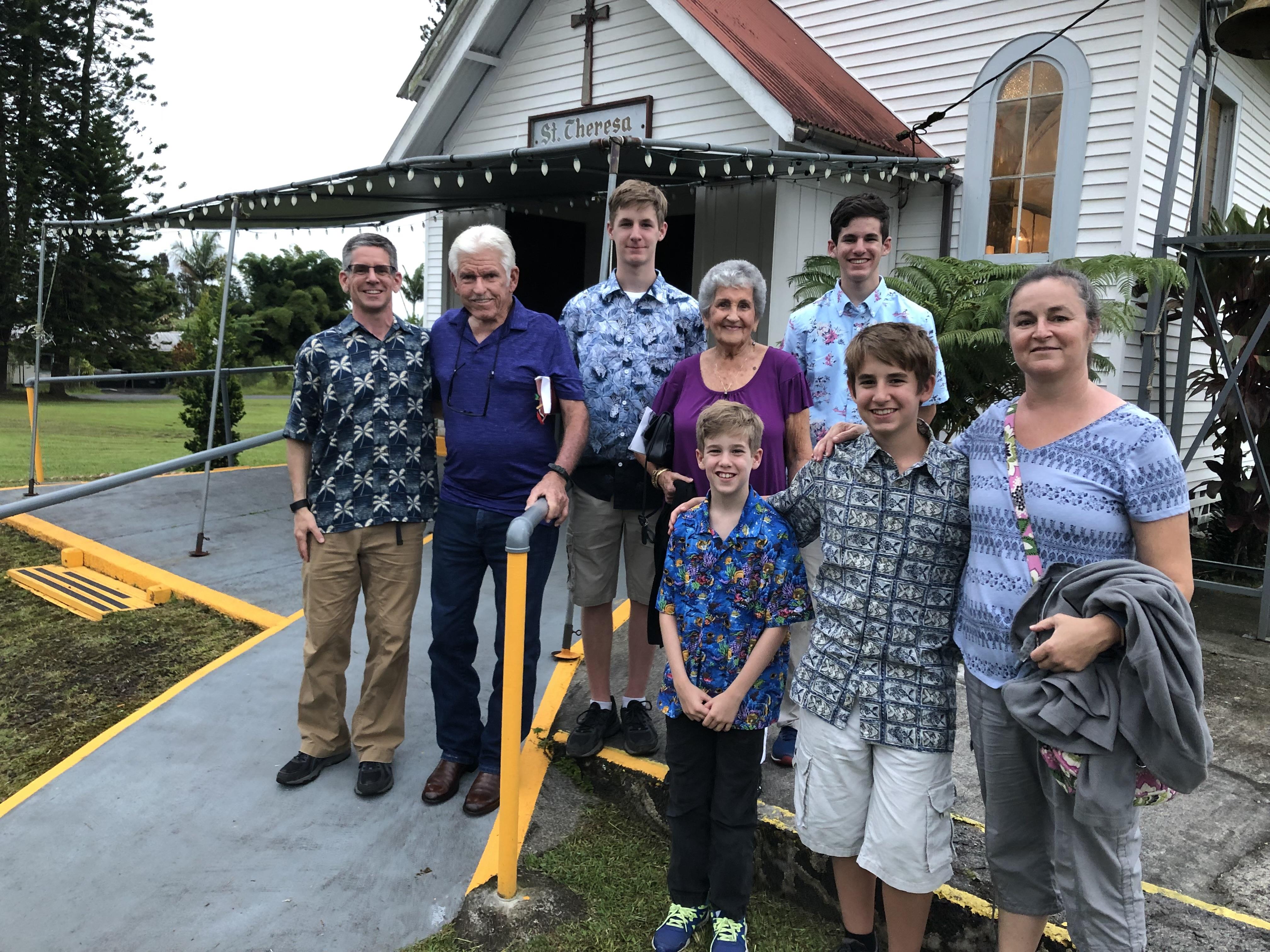 A group of people standing in front of a church