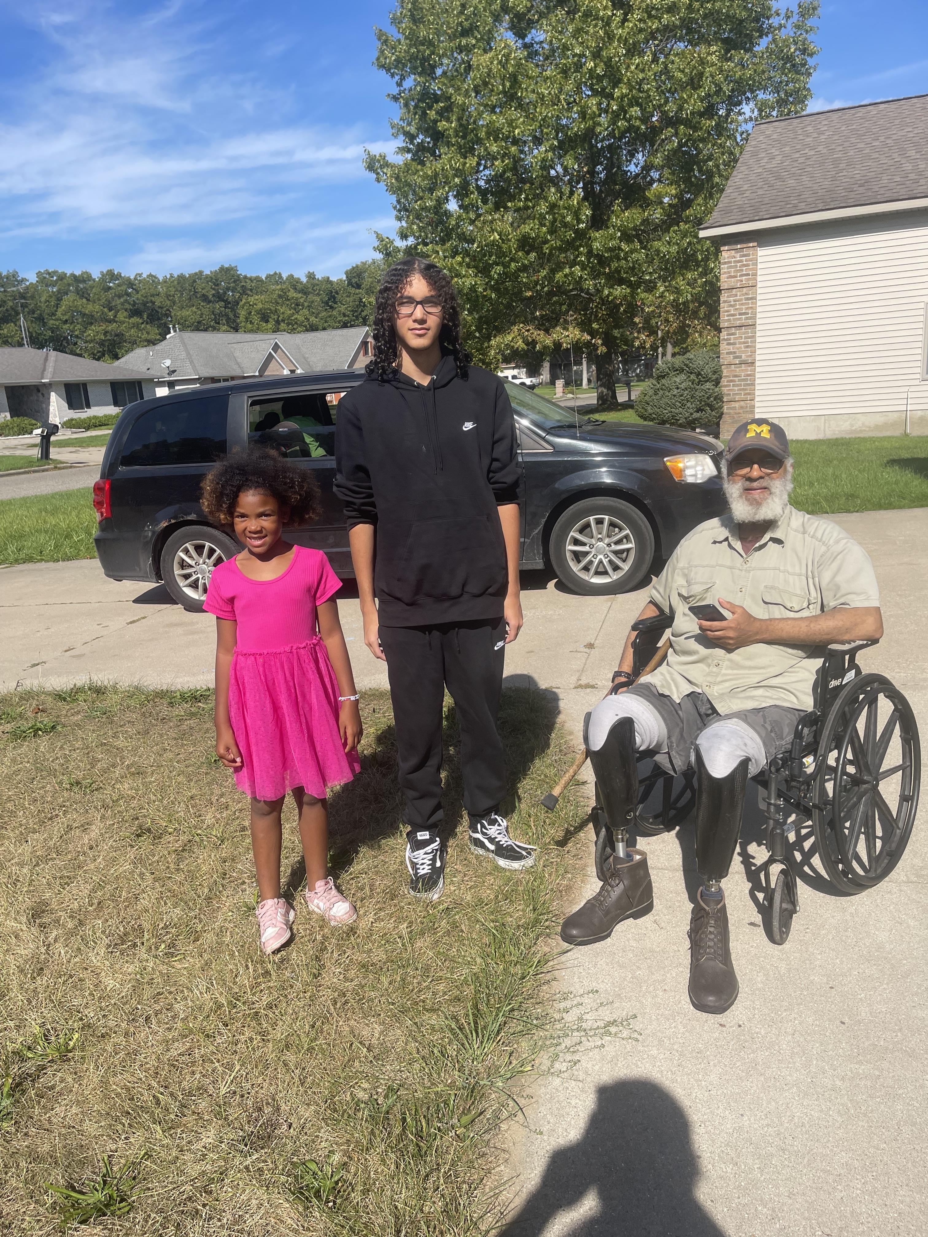 A man in a wheelchair with a girl in a wheelchair