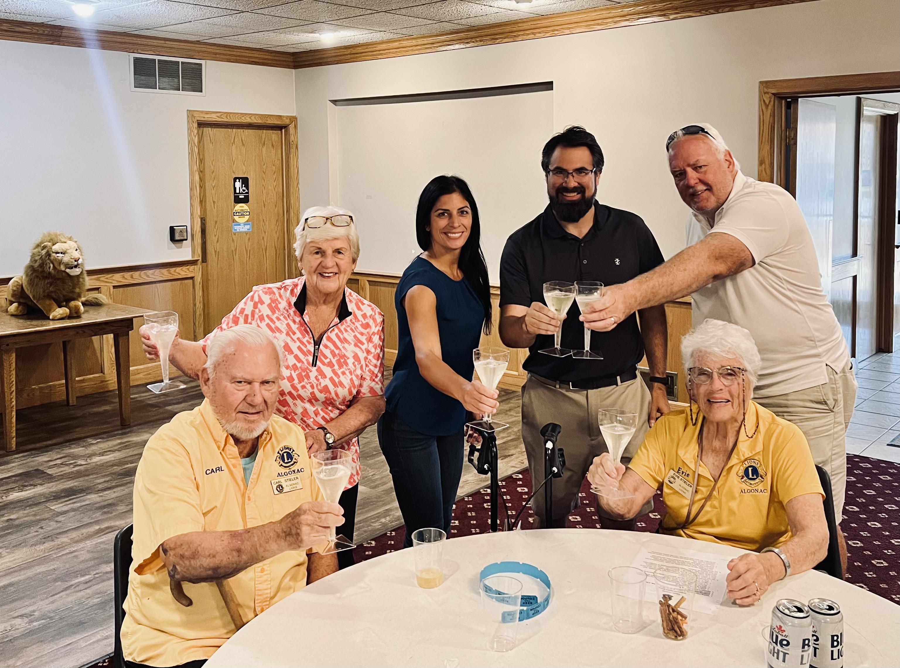 A group of people holding glasses of wine