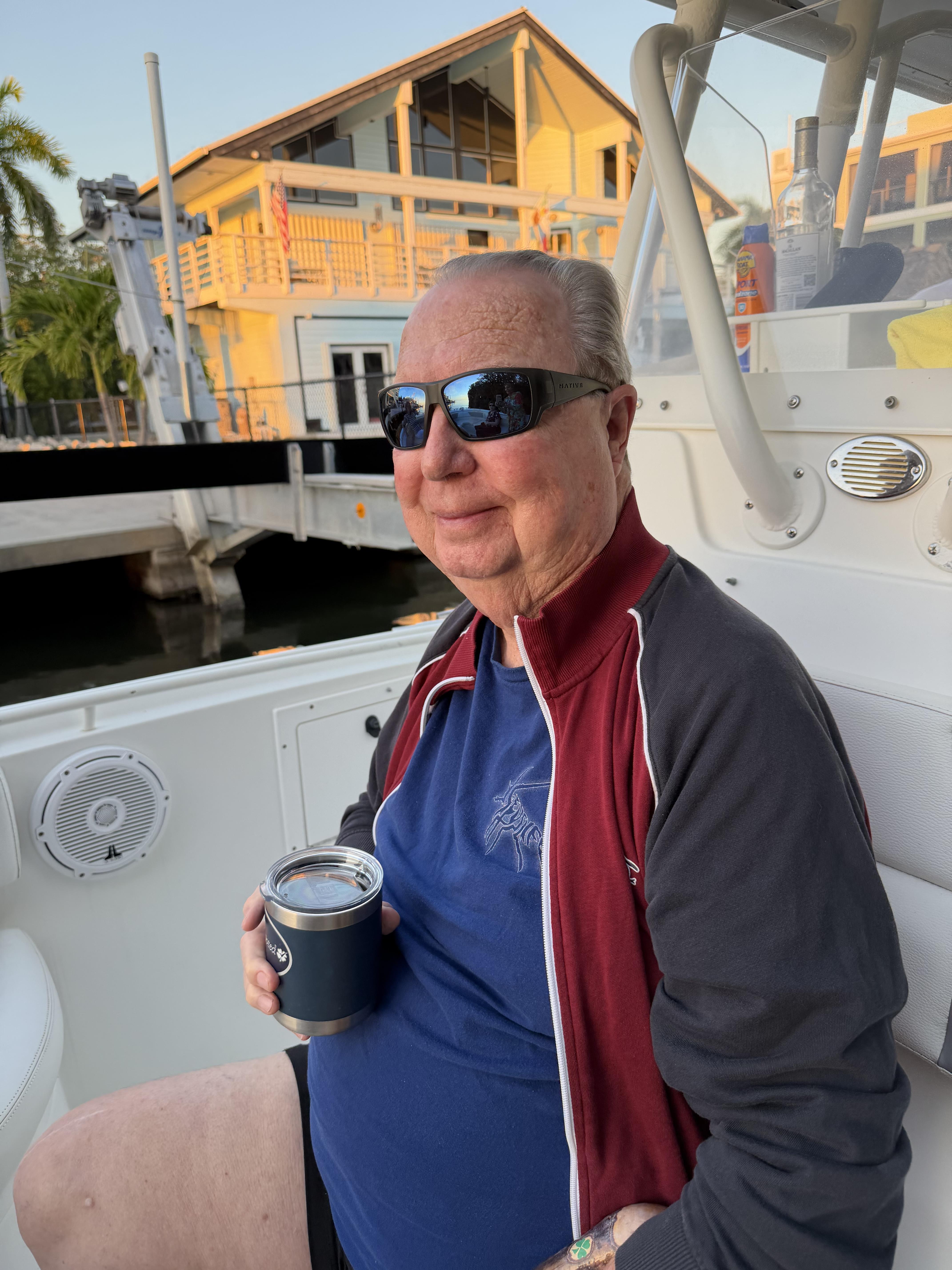 A man in sunglasses holding a can