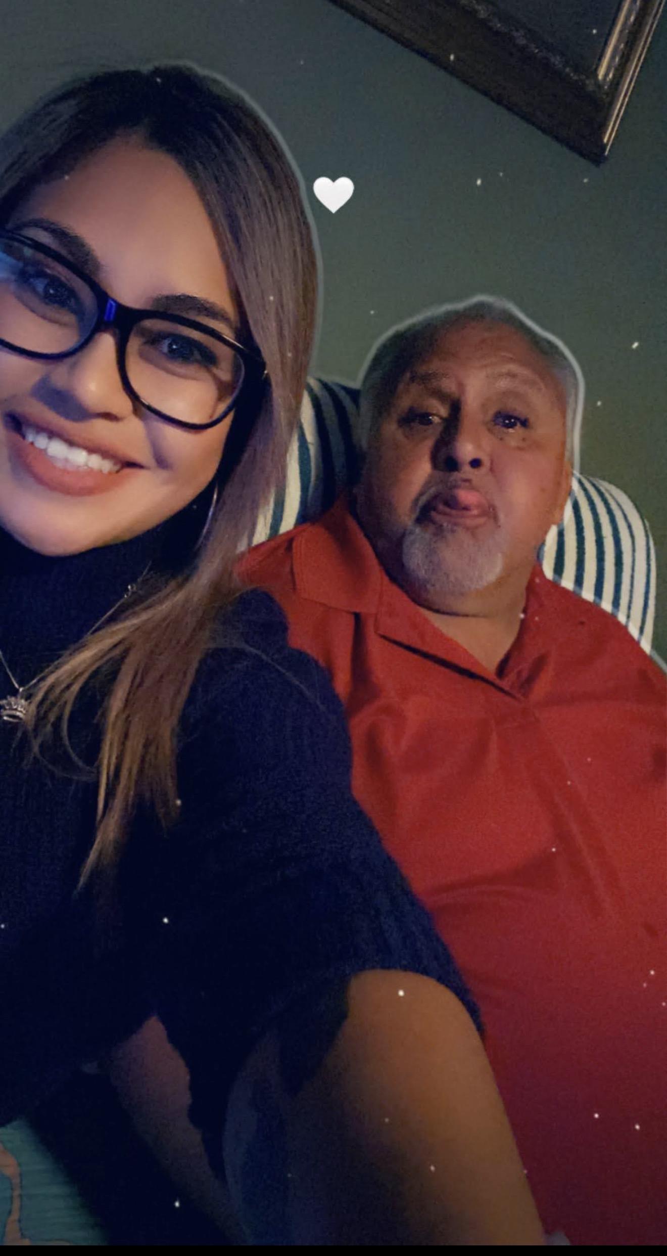 A woman taking a selfie with a man