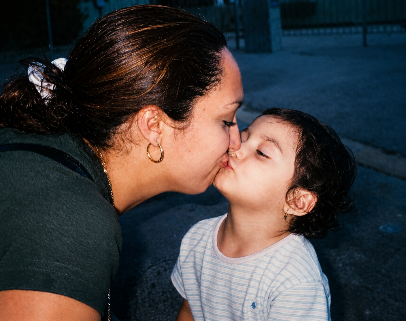 A woman kissing a child