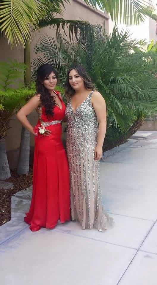 Two women in formal dresses posing for a picture