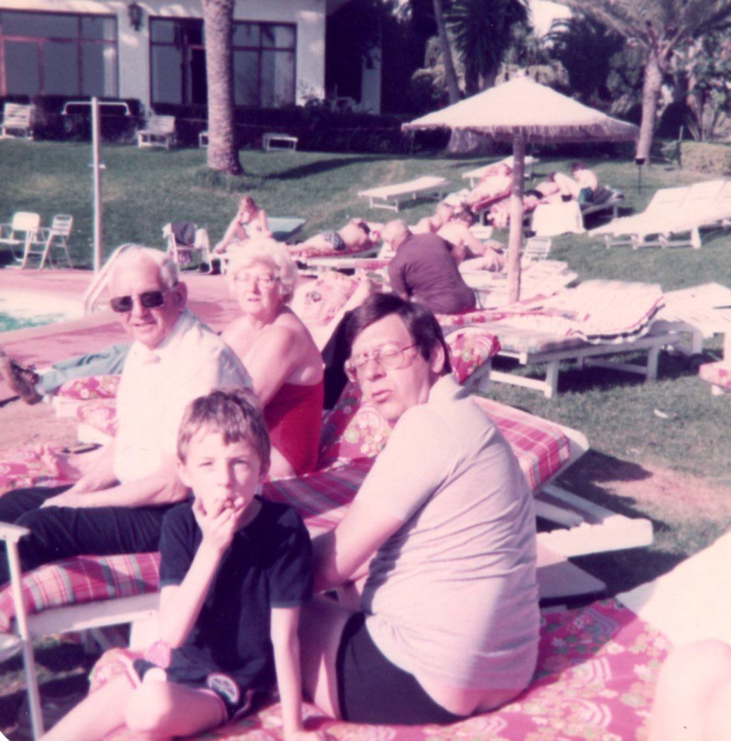 A group of people sitting on lounge chairs