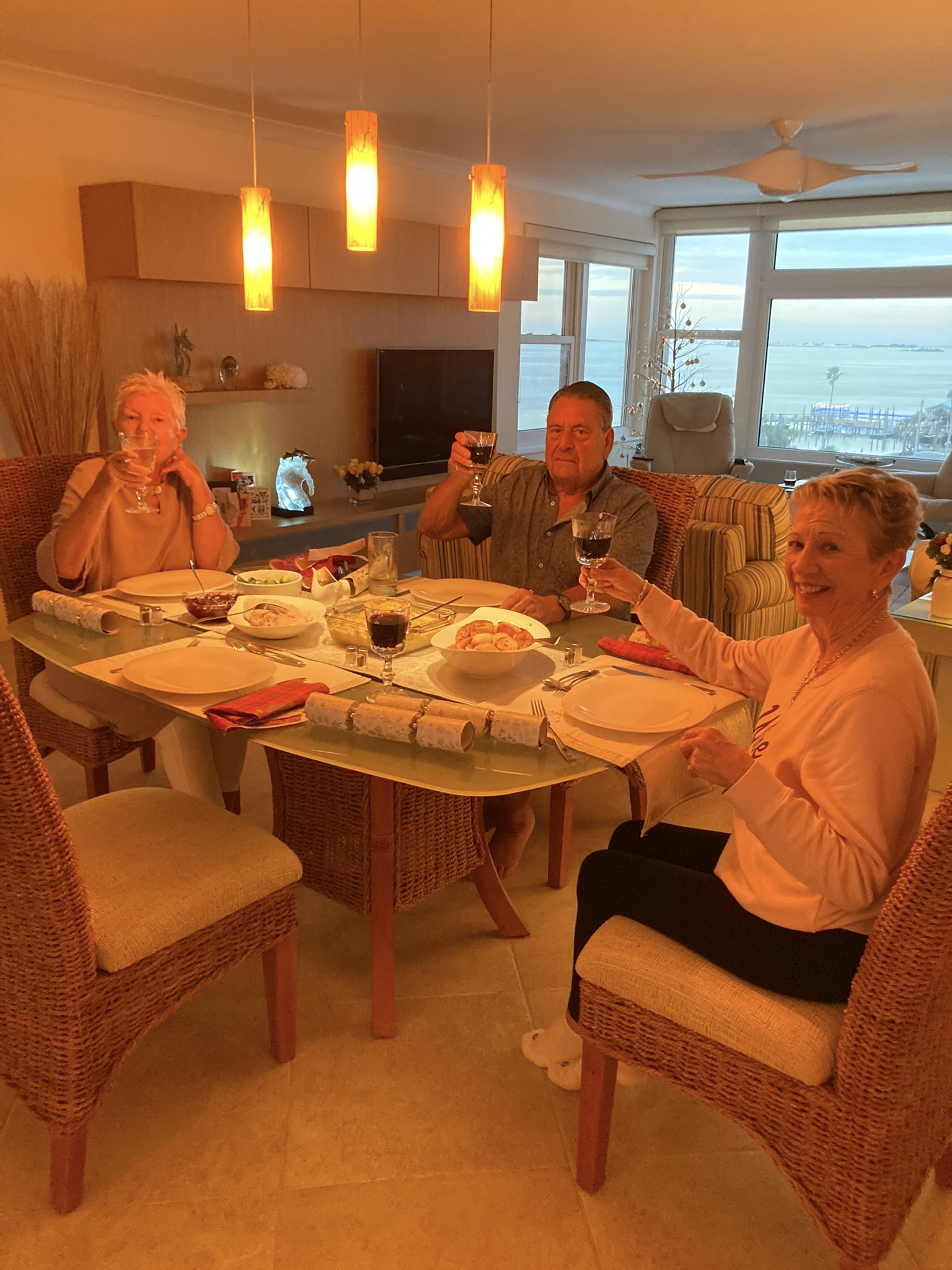 A group of people sitting at a table with wine glasses