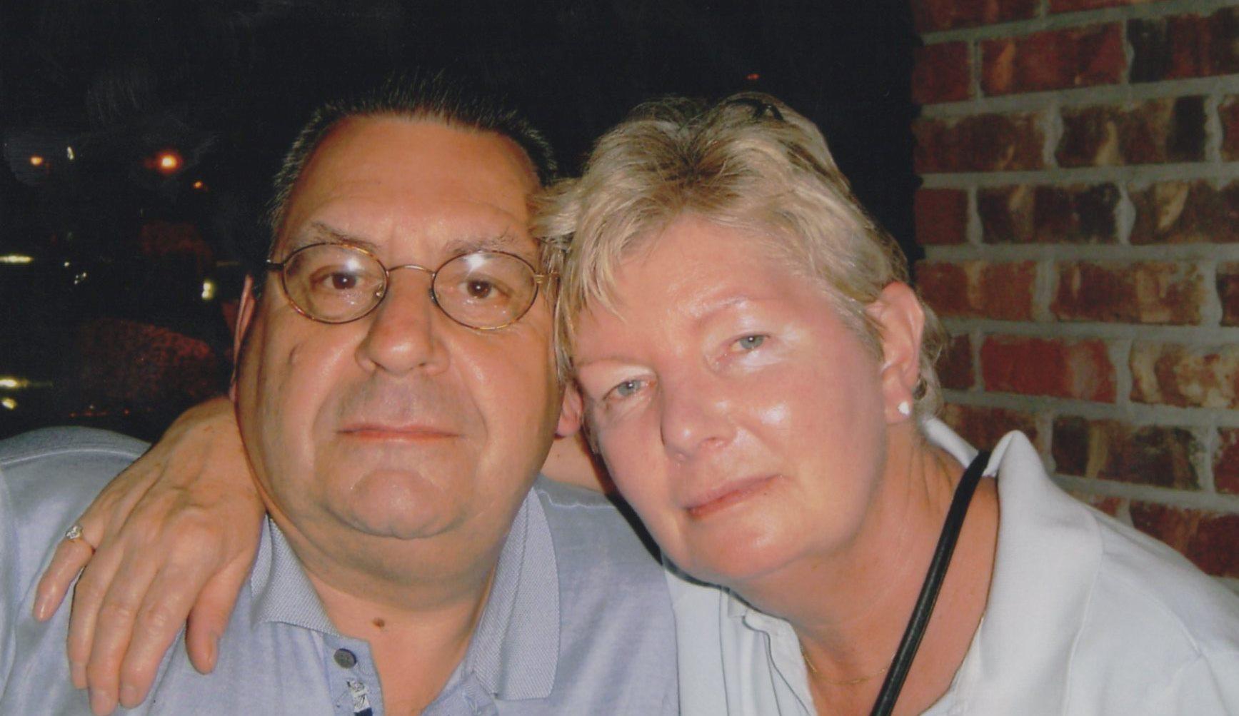 A man and woman posing for a picture