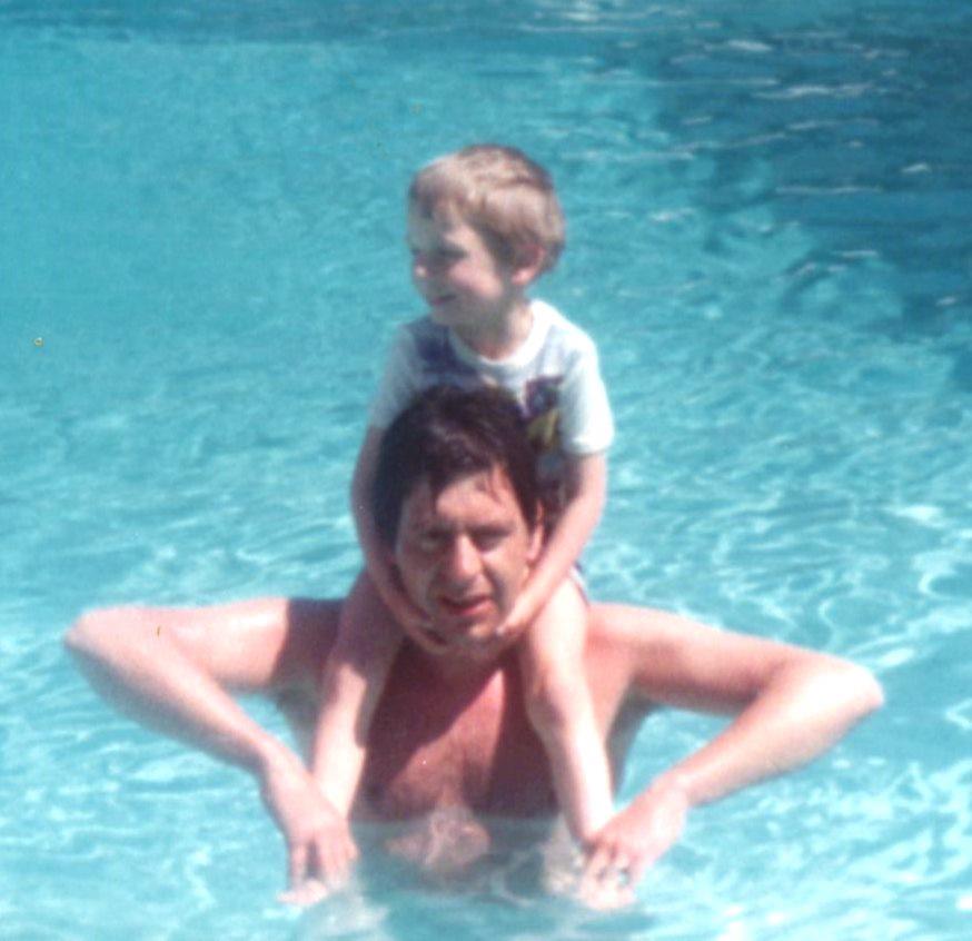 A man and child in a pool