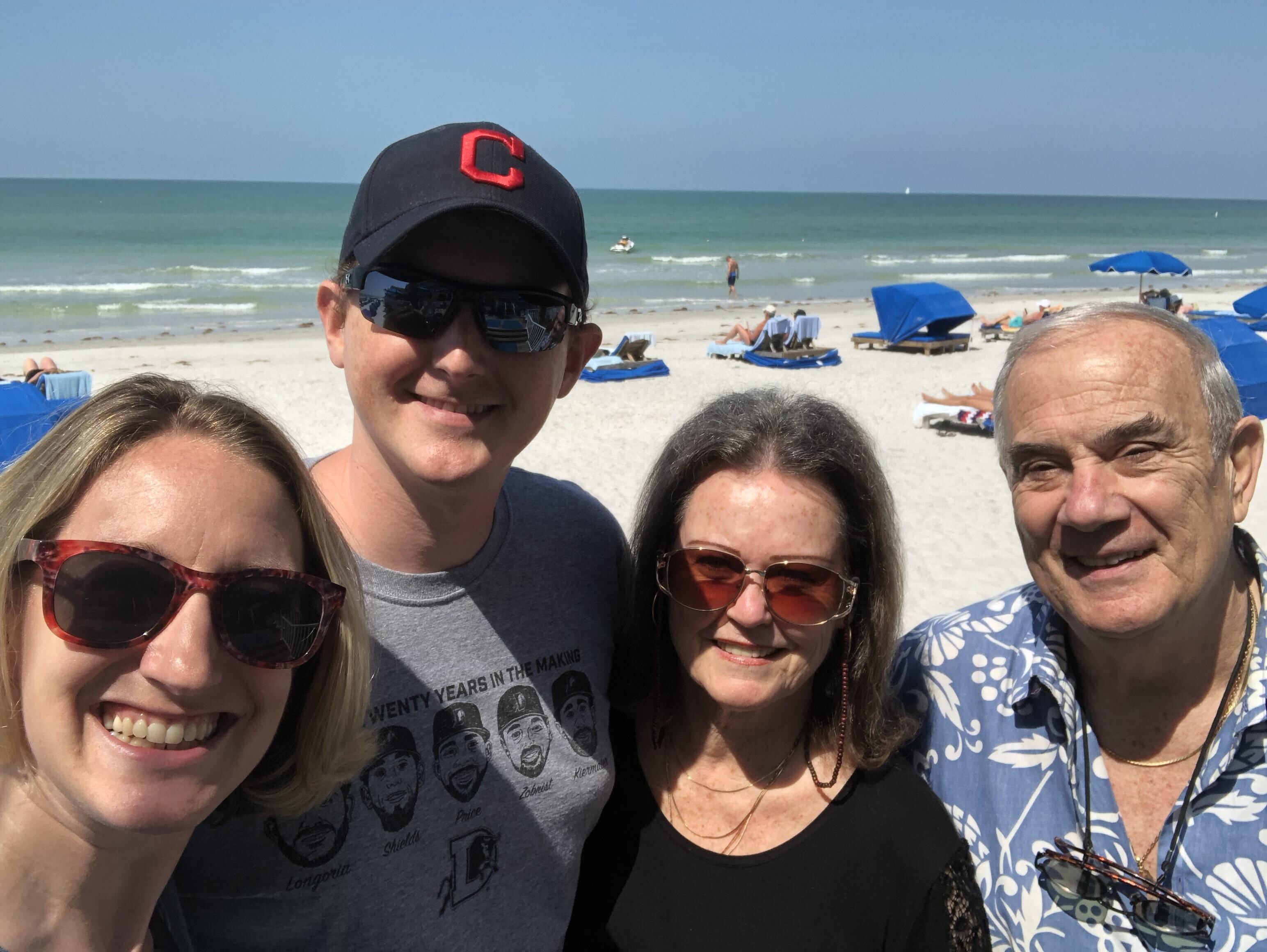 A group of people posing for a photo on a beach