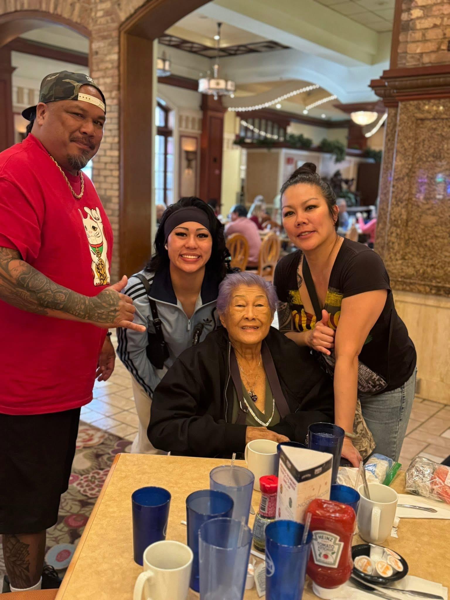 A group of people standing around a woman