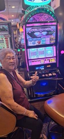 A woman sitting in a casino with a machine