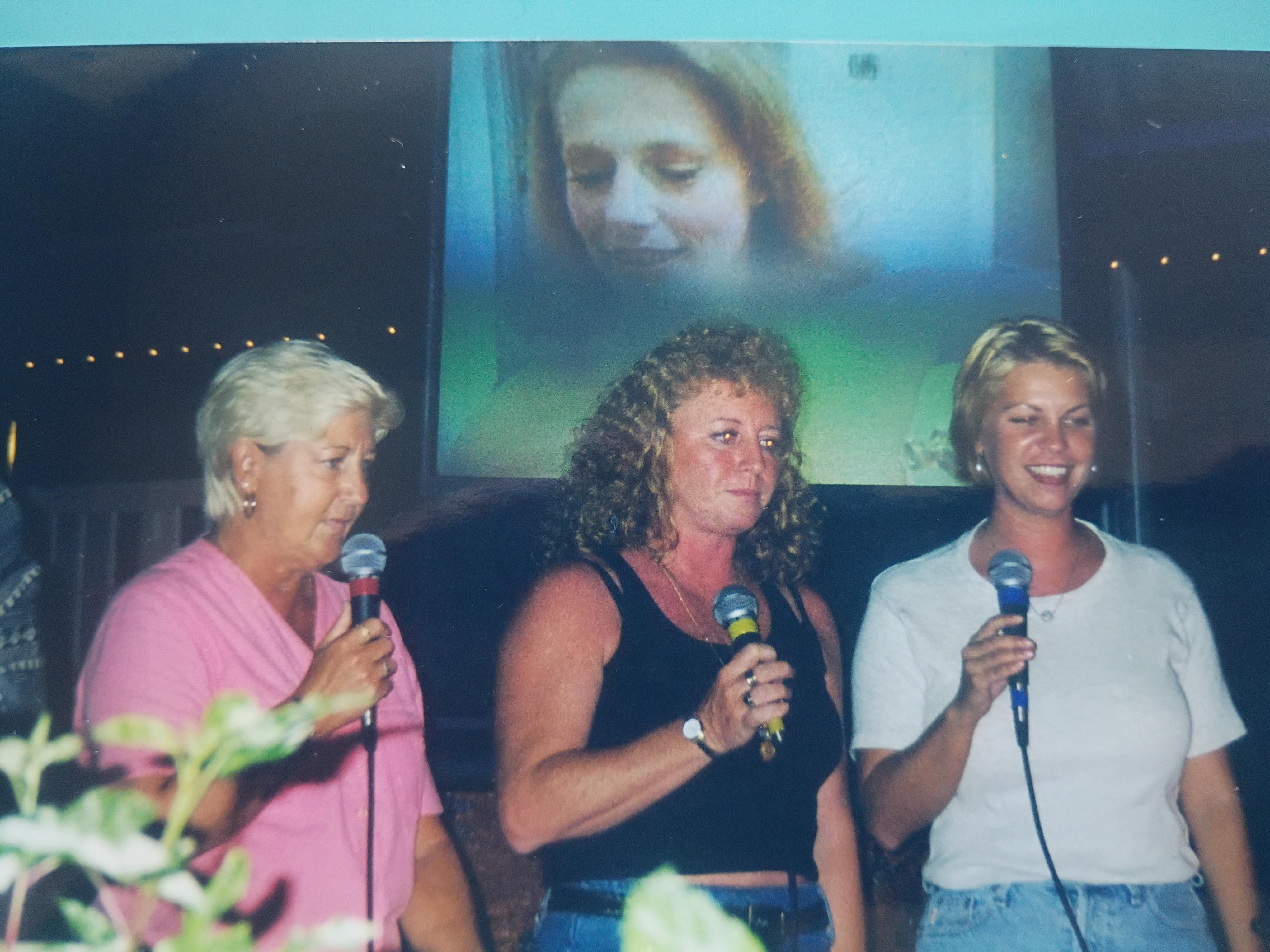 A group of women holding microphones