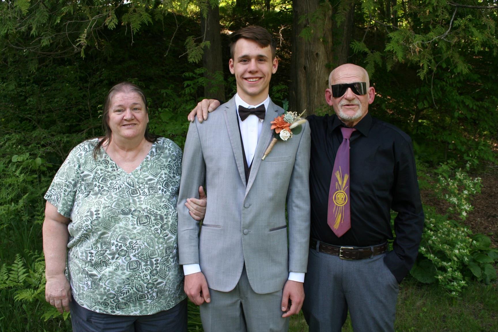A man in a suit with his arm around a man in a suit