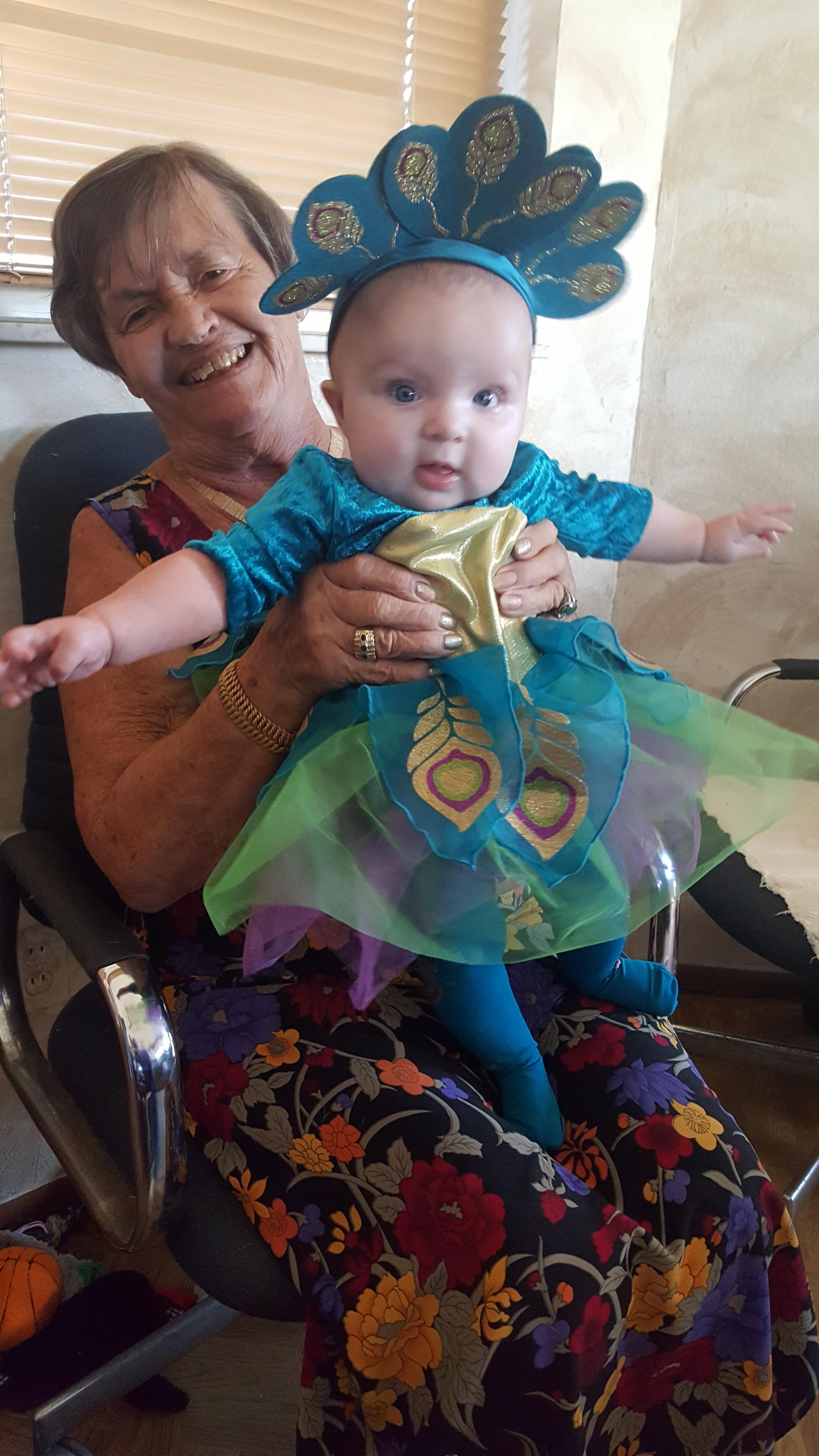 An old woman holding a baby