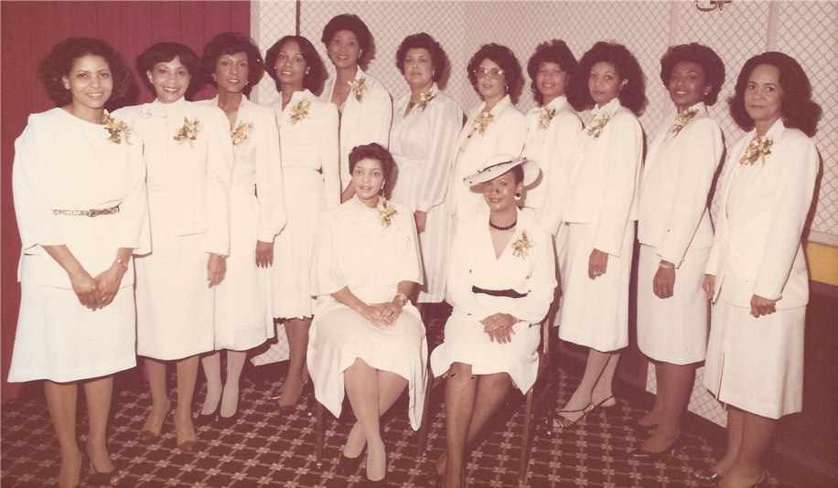 A group of women in white dresses