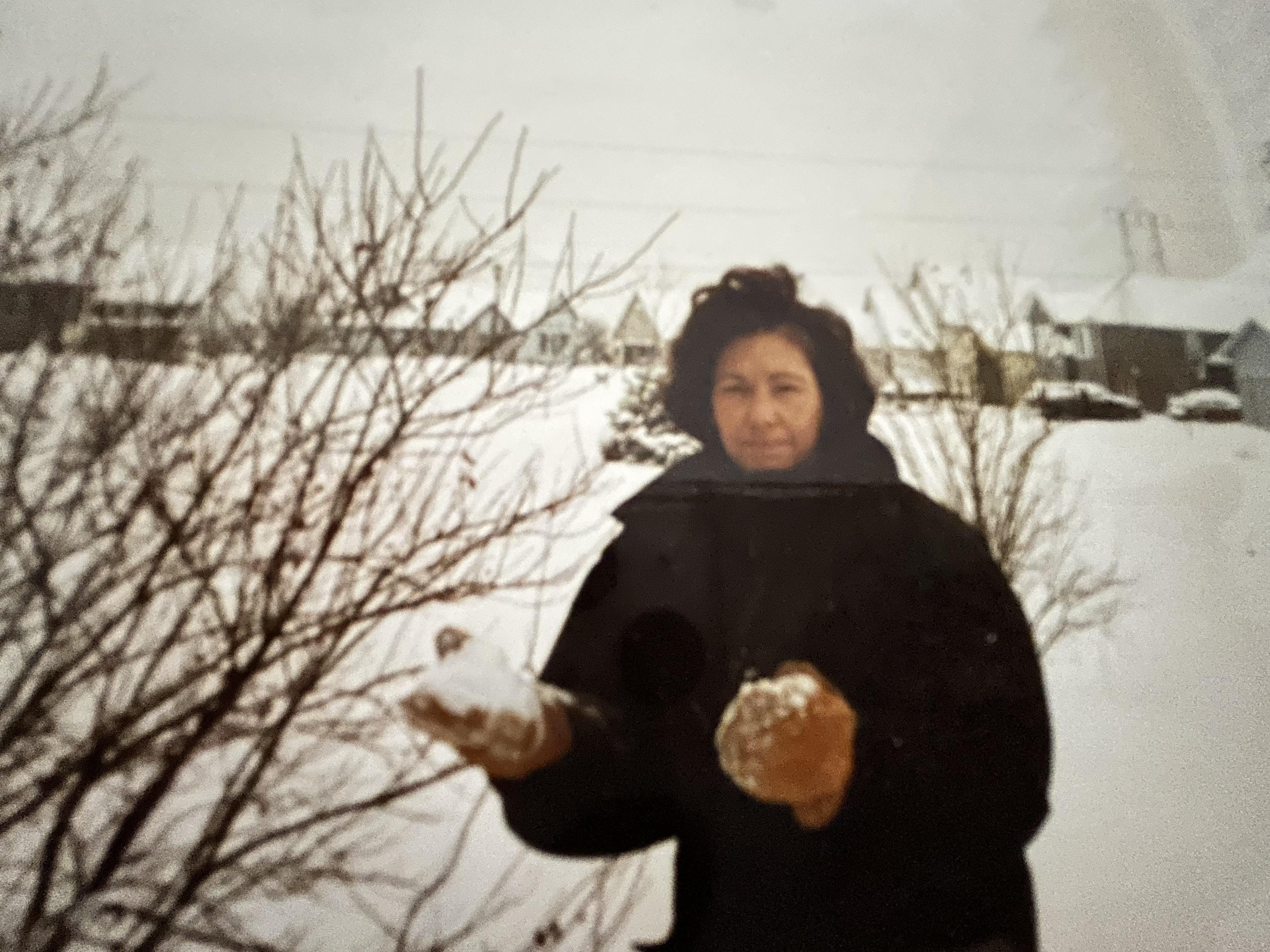 A woman holding snow in her hand