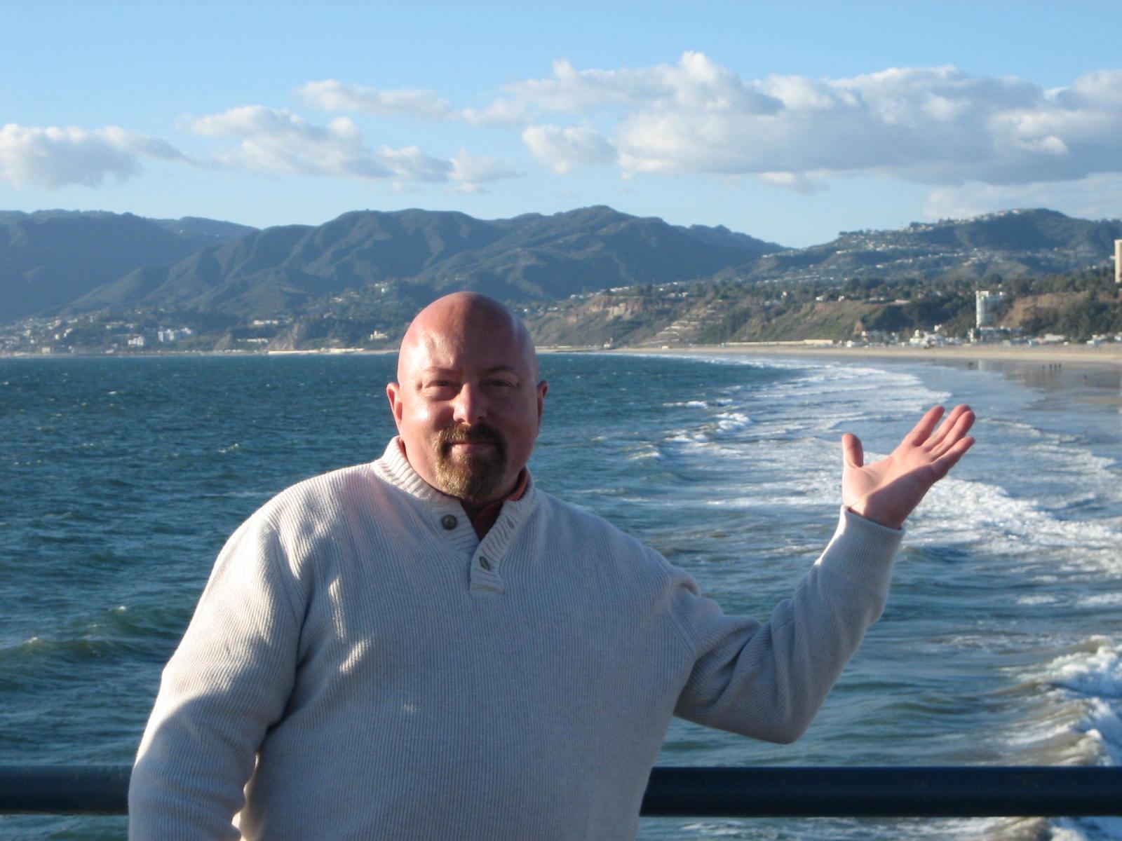 A man standing in front of a body of water