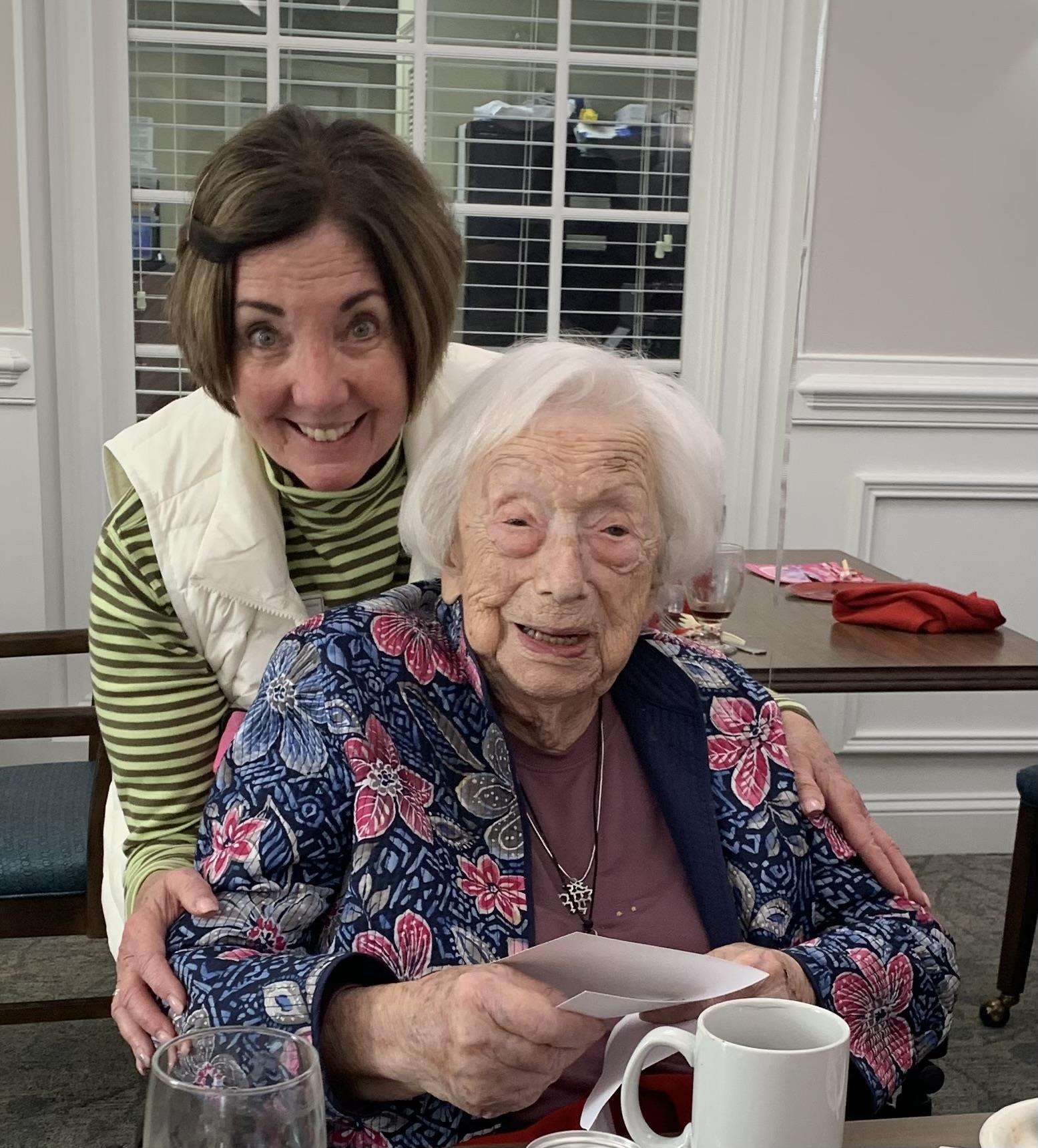 A woman hugging an old woman