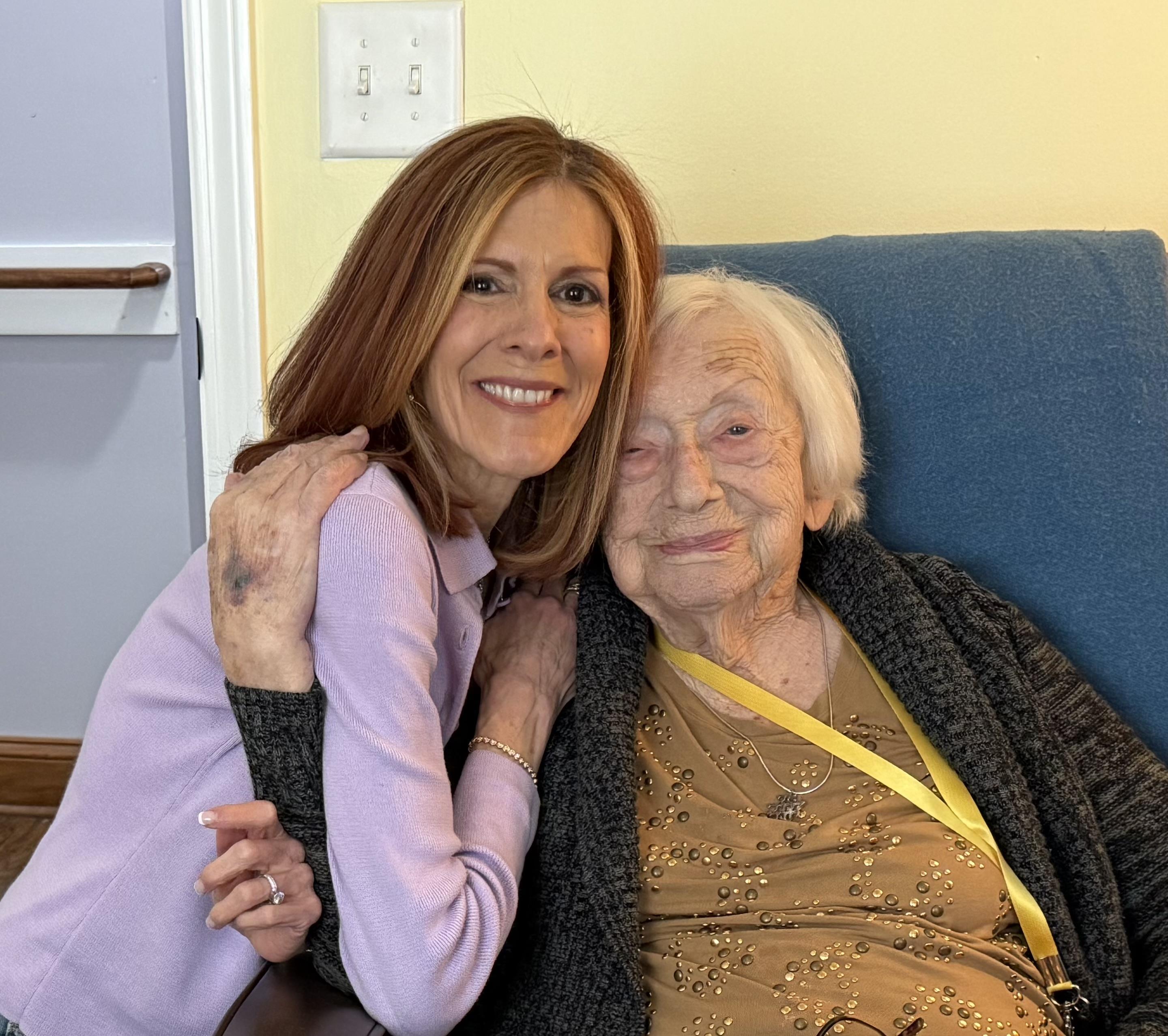 A woman and an older woman sitting on a couch