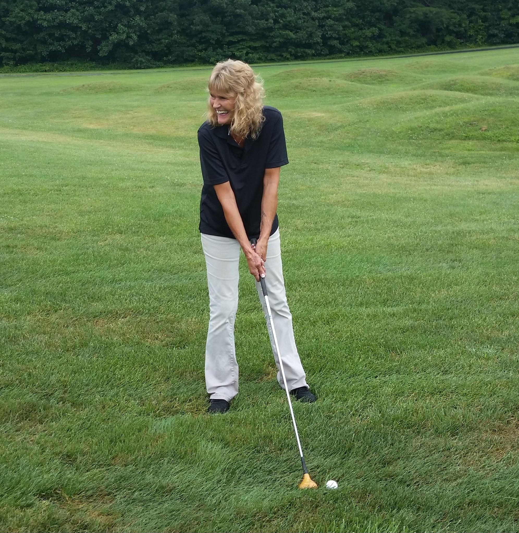 A woman playing golf on a golf course