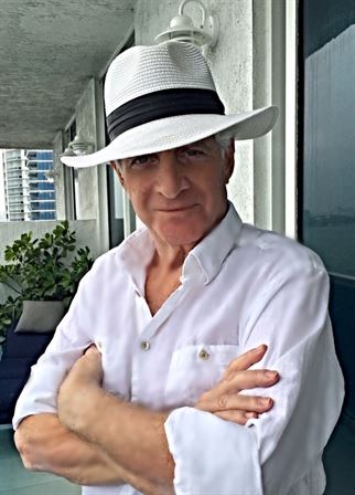A man wearing a hat and white shirt