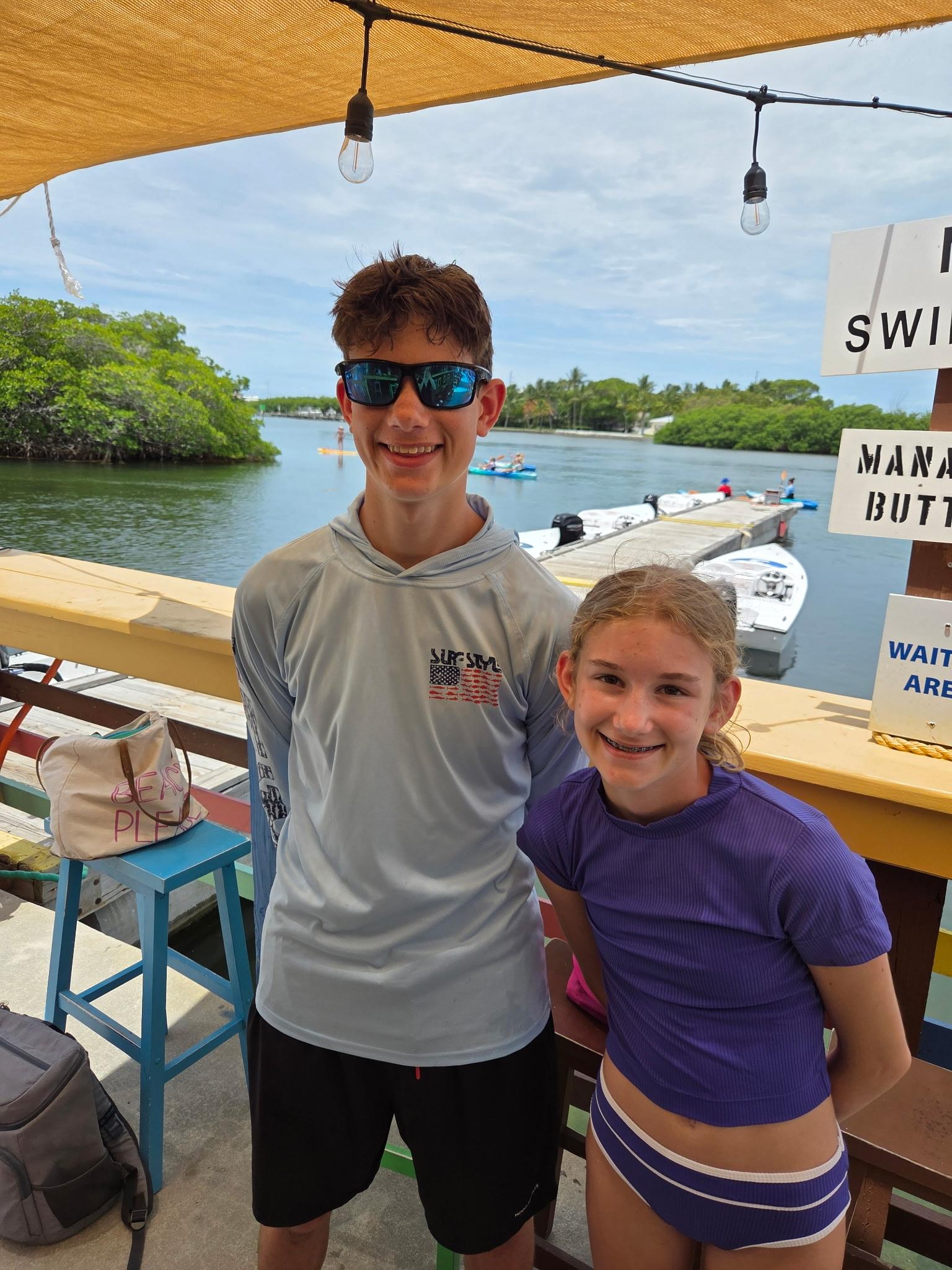 A boy and girl posing for a picture