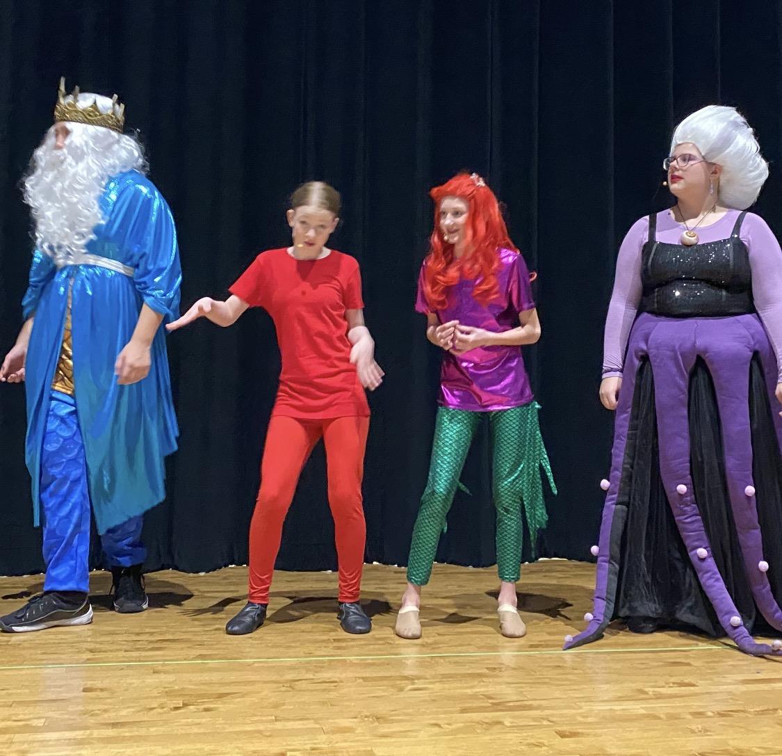 A group of people in clothing on a stage