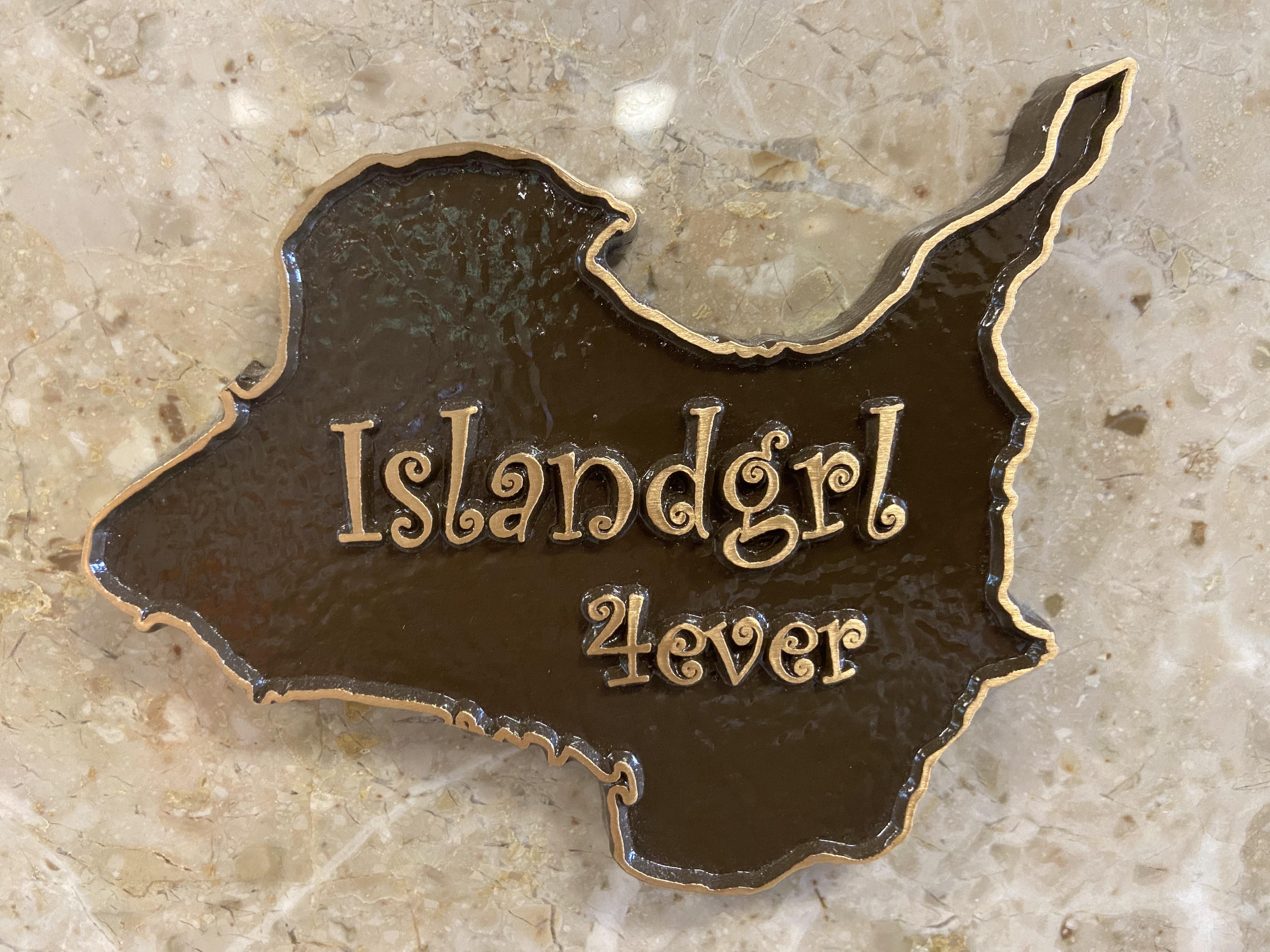 A brown and gold sign on a marble surface