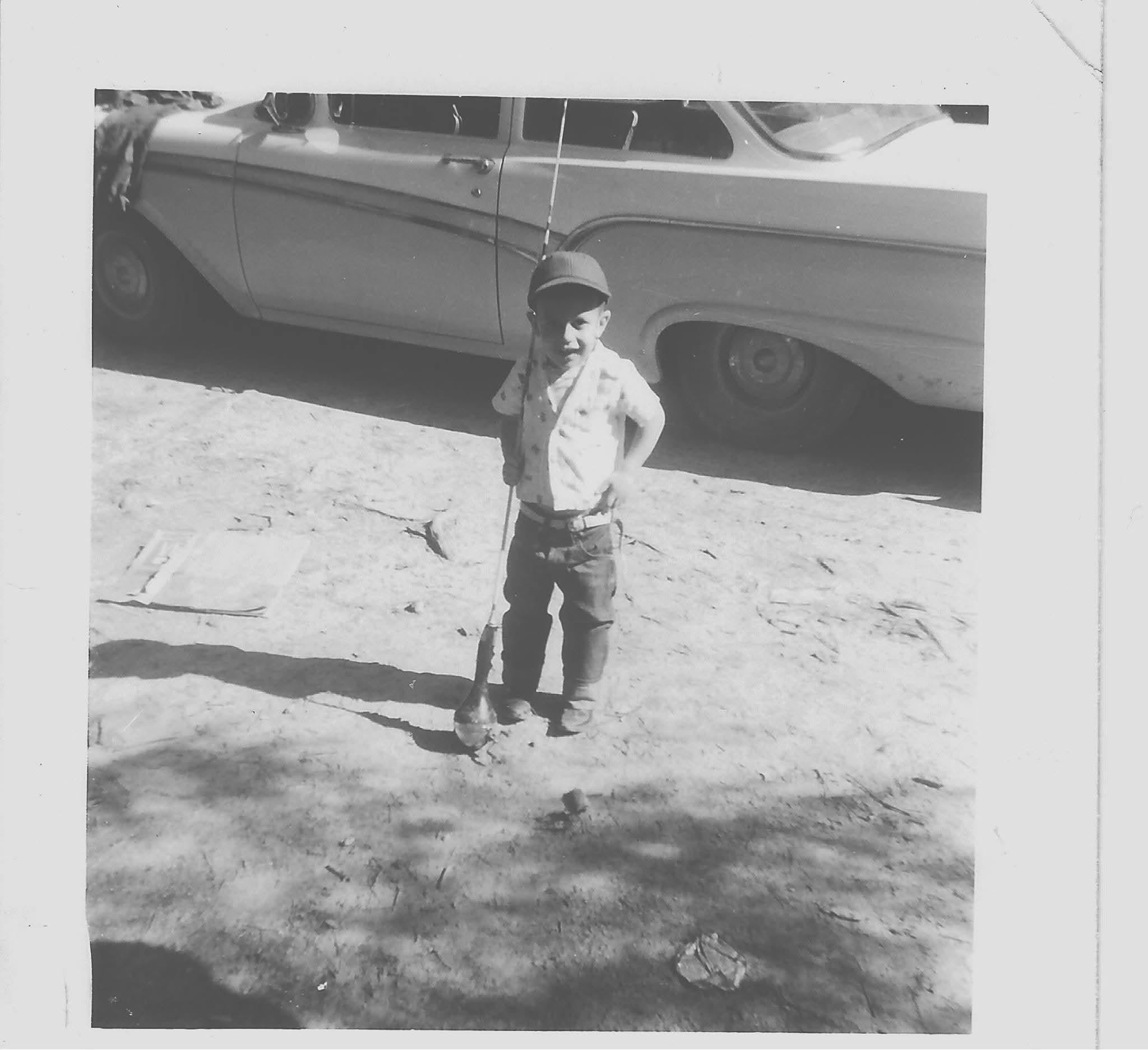 A child standing in front of a car
