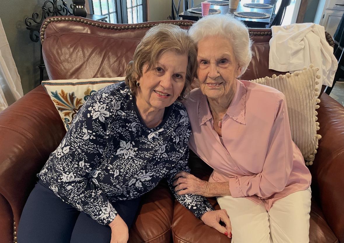 Two women sitting on a couch