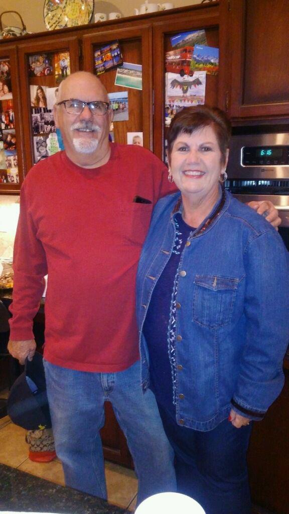 A man and woman standing in a kitchen