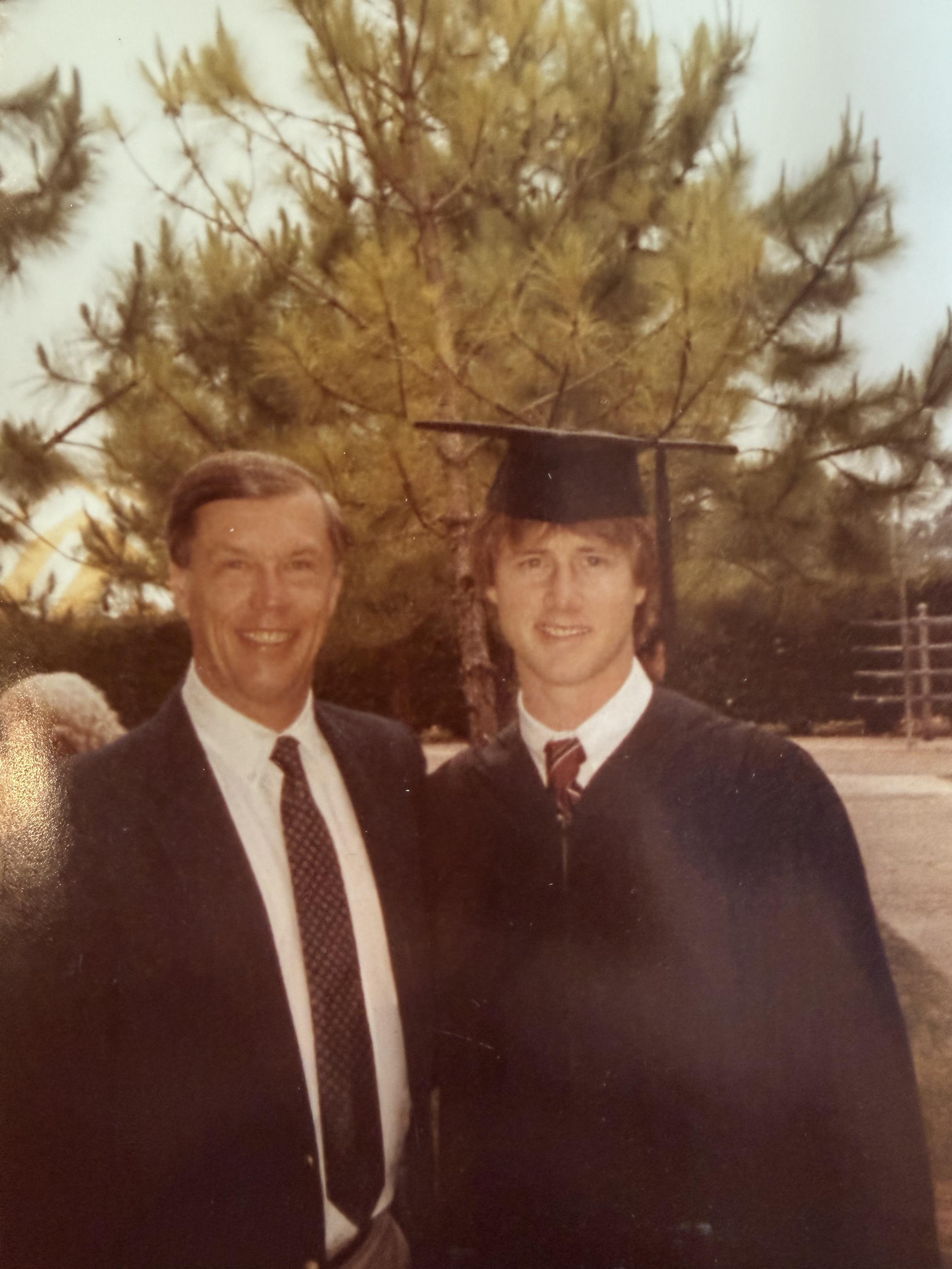 A man and a boy in graduation attire