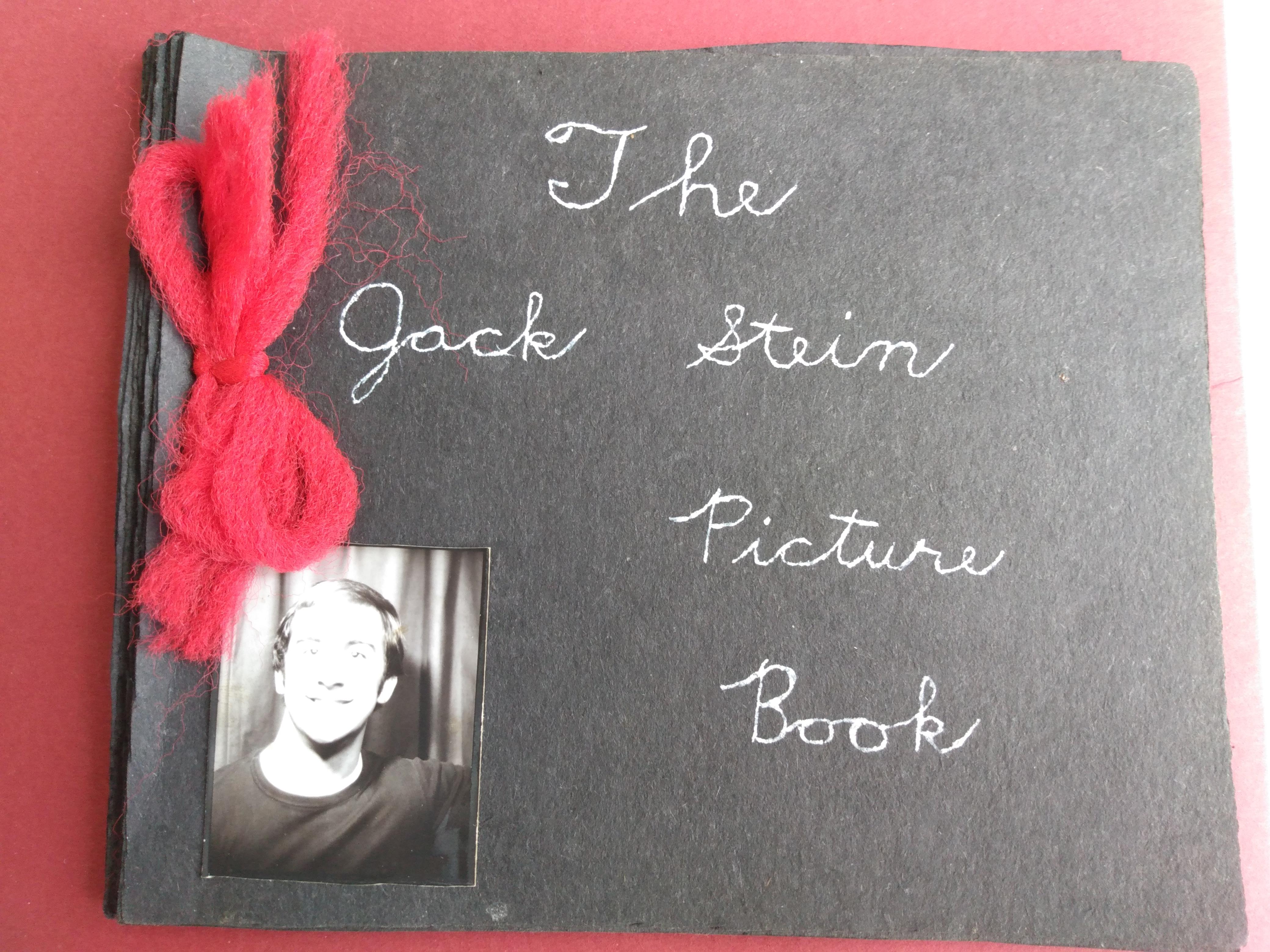 A black book with a red string and a photo of a man