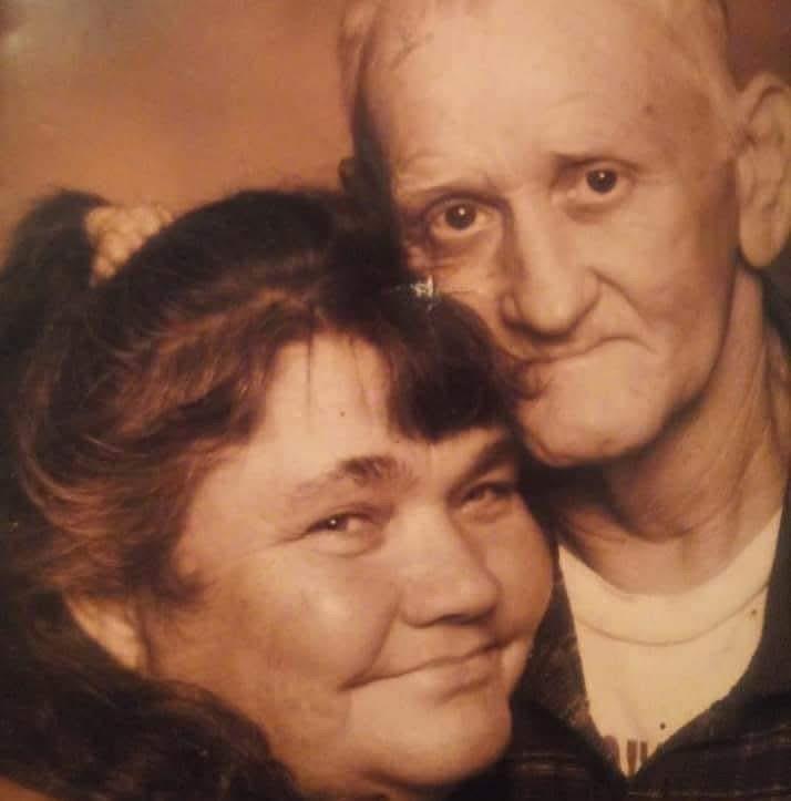 A man and woman posing for a picture