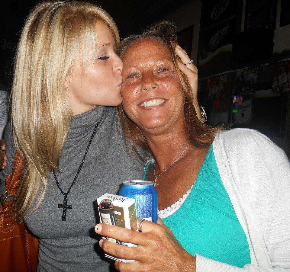 A woman kissing another woman