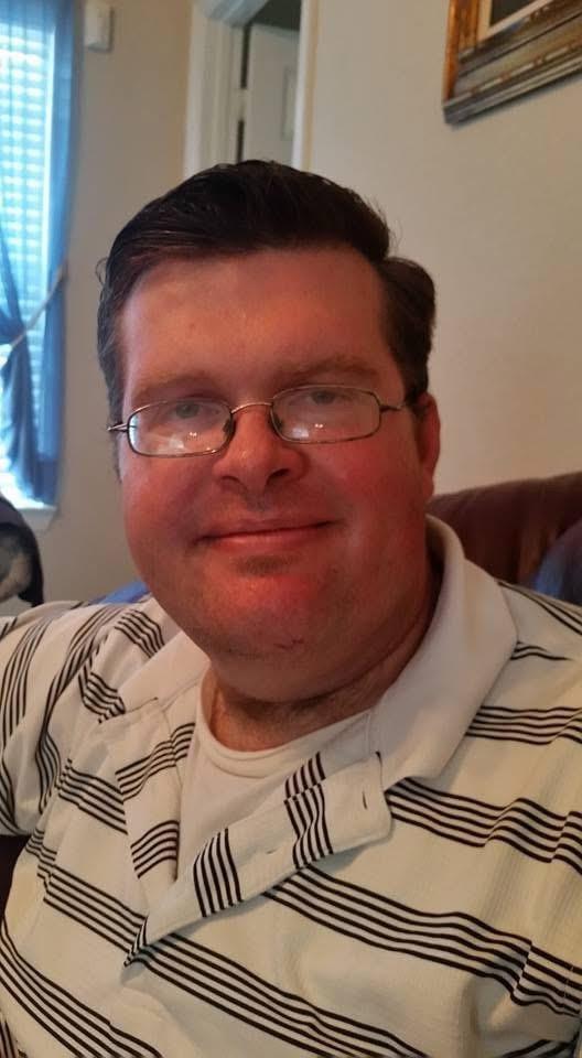 A man wearing glasses and a striped shirt